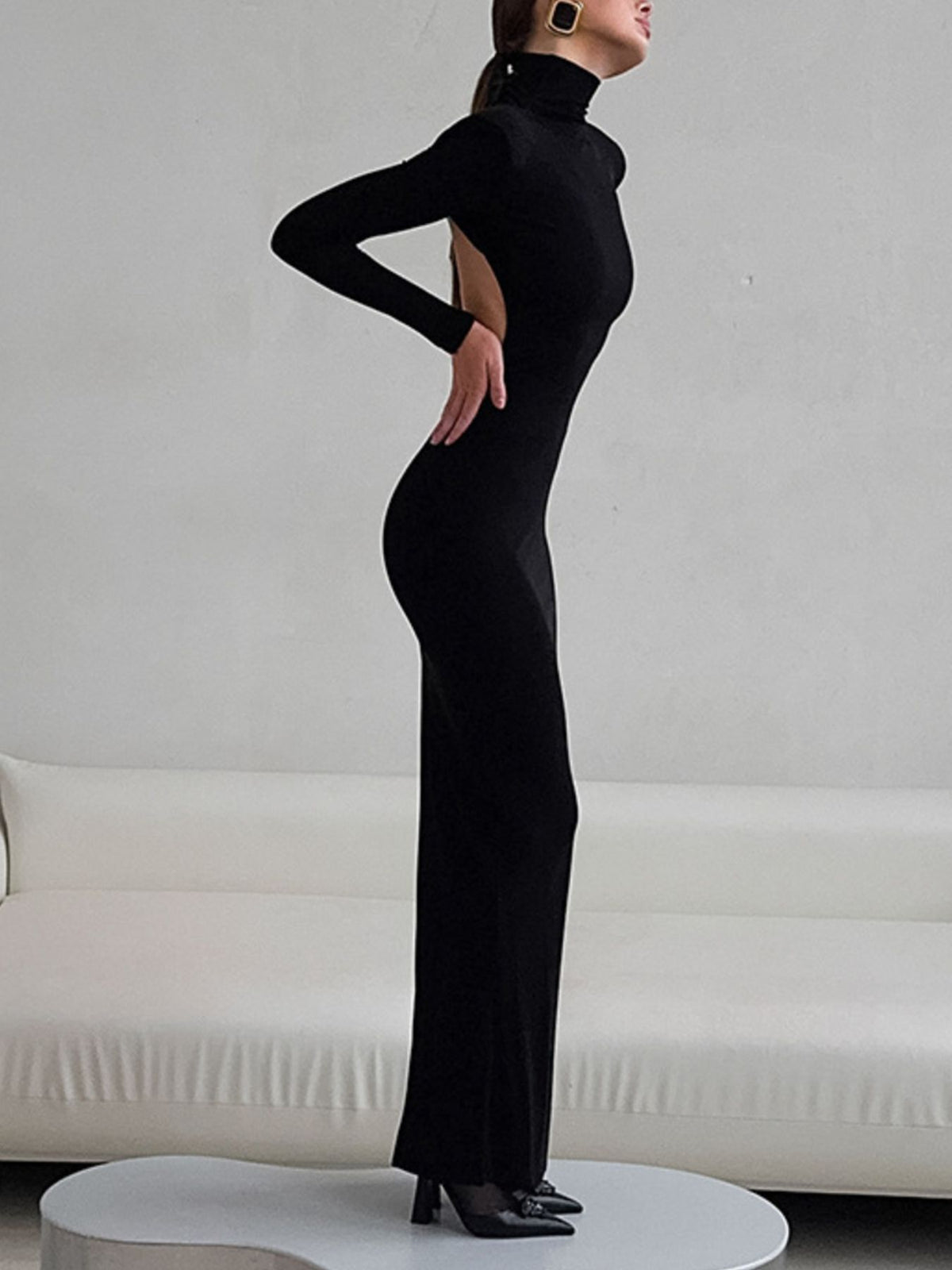 Side view of black turtleneck bodycon maxi dress on model