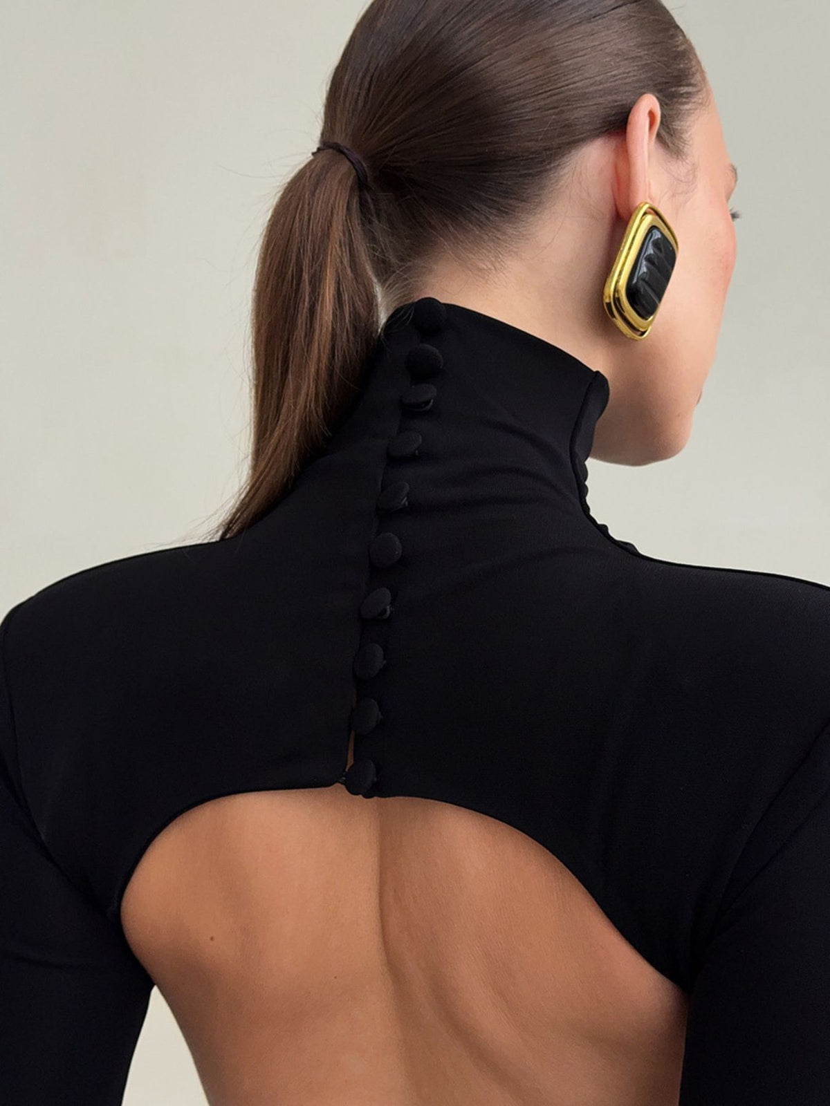 Close-up of black bodycon maxi dress turtleneck with back button closure