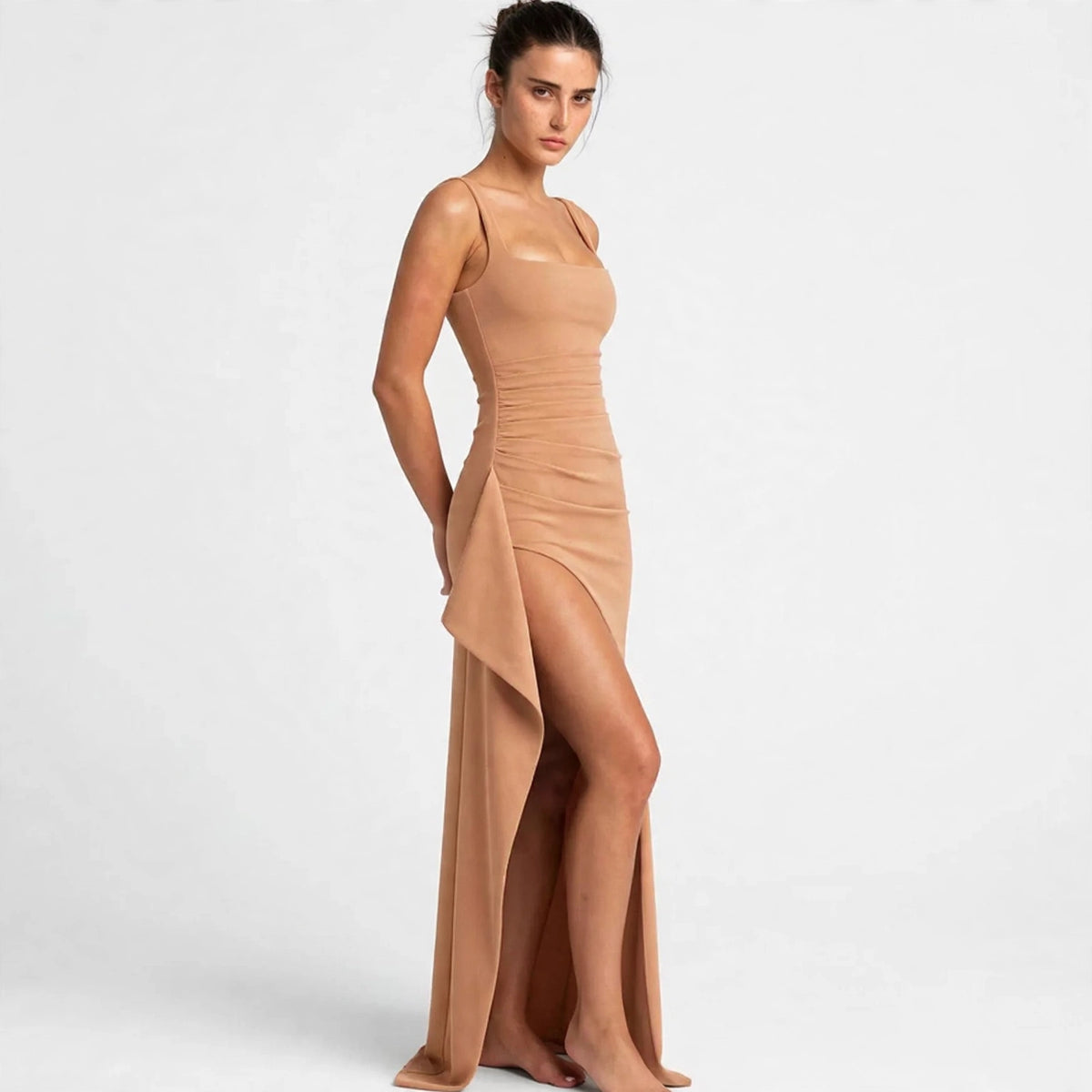 Three-quarter view of an apricot ruched high-slit maxi dress with high slit