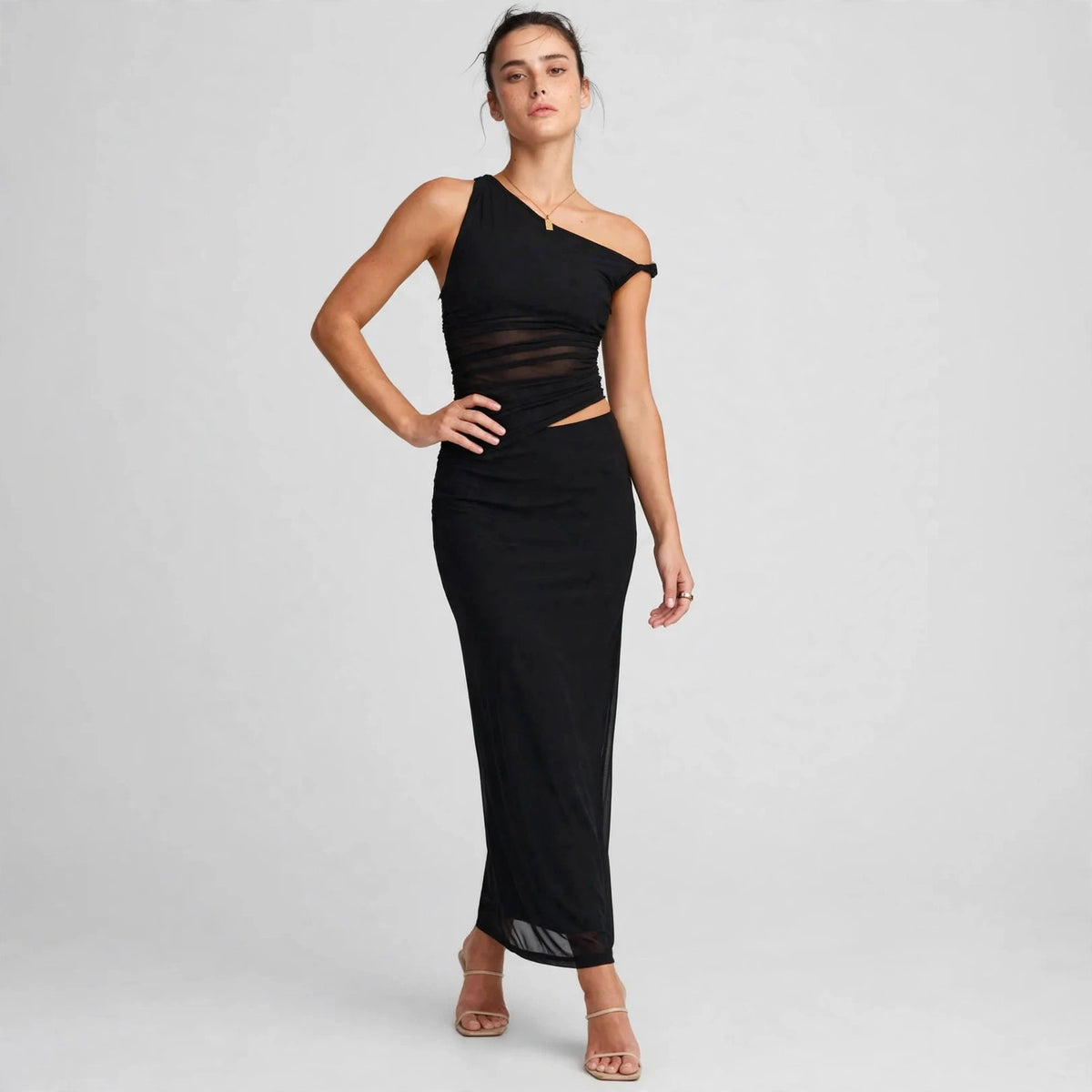 black asymmetrical cutout maxi dress – front view, hand on hip