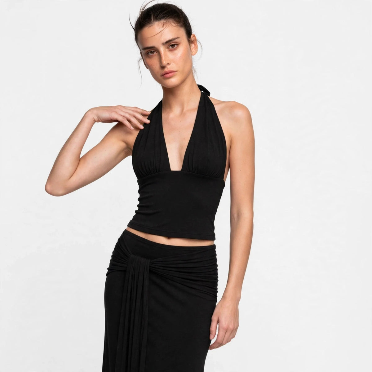 Side view of black halter top and draped maxi skirt set