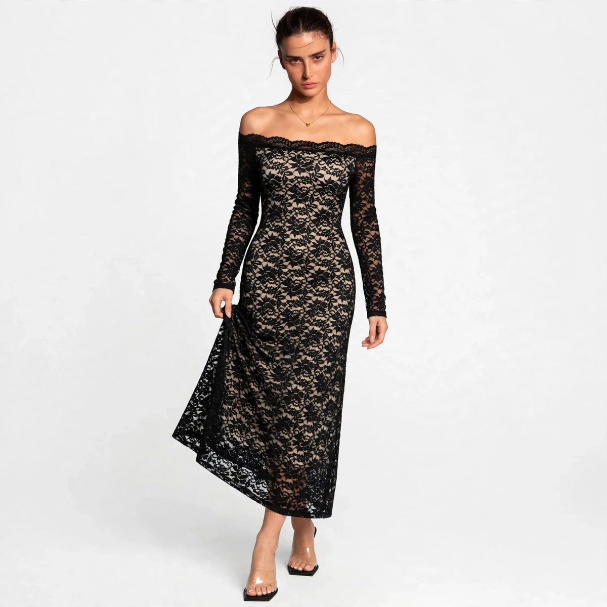 Woman wearing a black off-shoulder lace maxi dress with long sleeves, front view