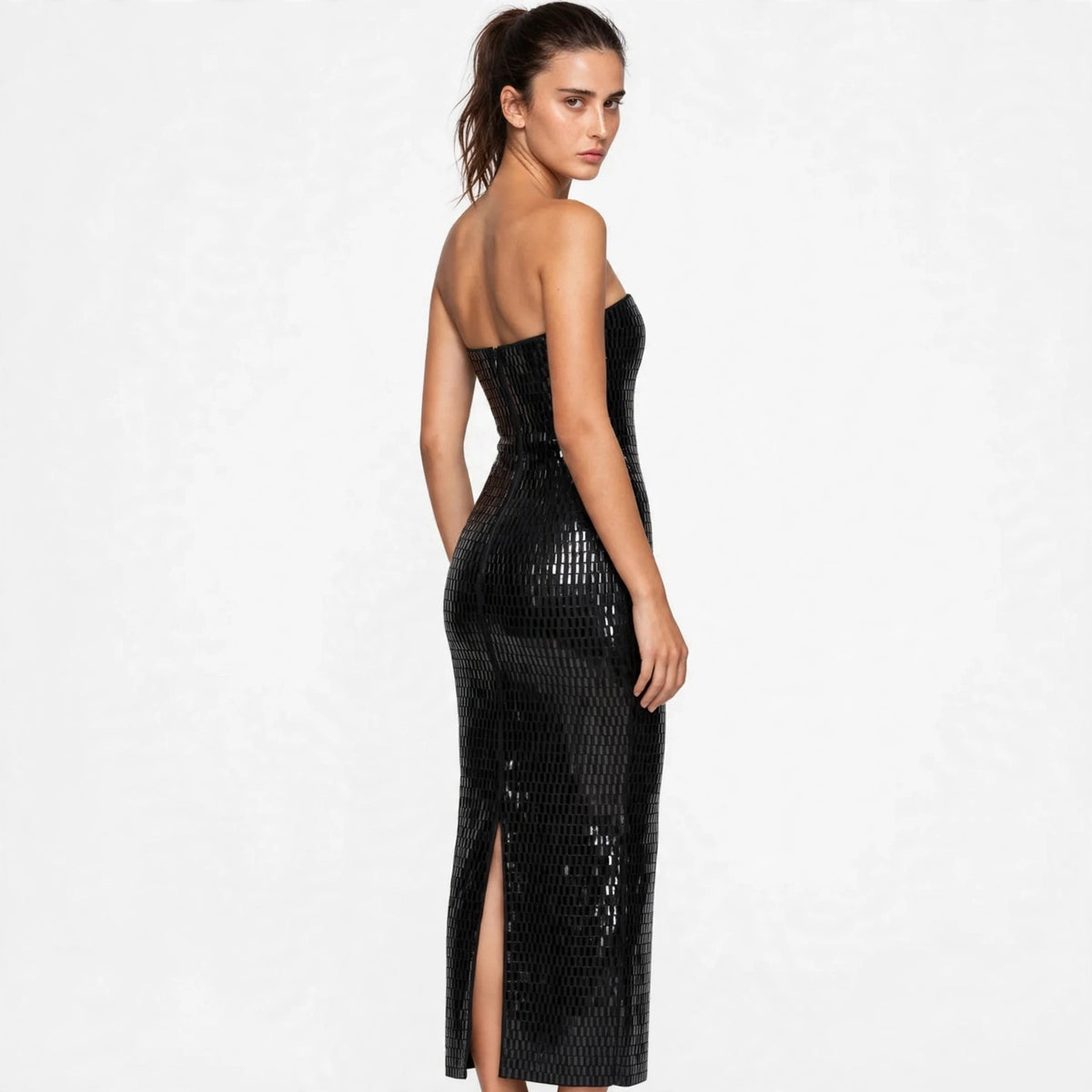Three-quarter back view of black sequin strapless tube maxi dress with slit