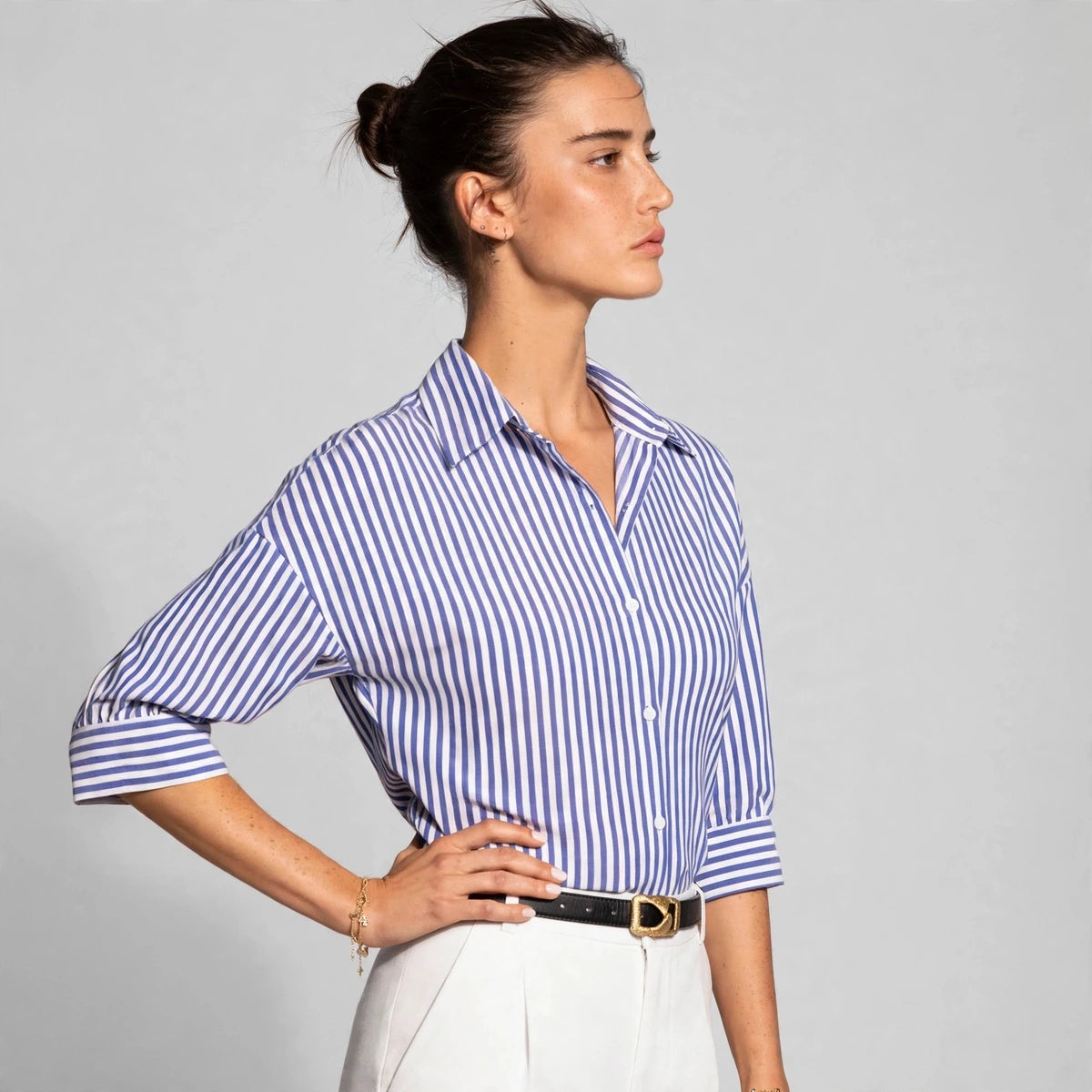 Three-quarter view of blue and white striped button-down shirt with collar