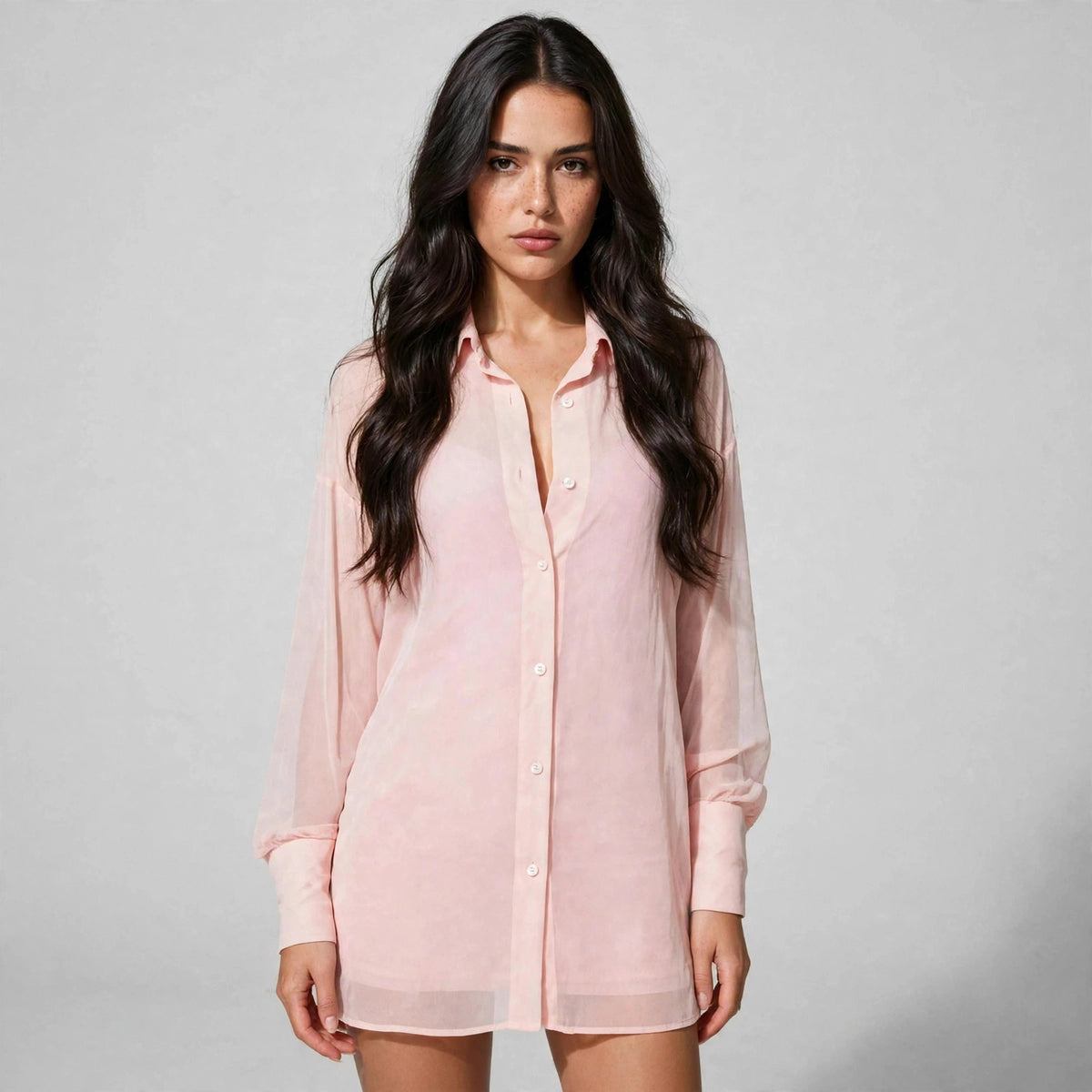 Close-up of blush pink button-down dress with sheer shirt