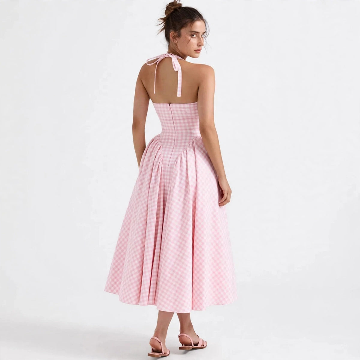 Back view of blush pink gingham halter maxi dress with tie closure
