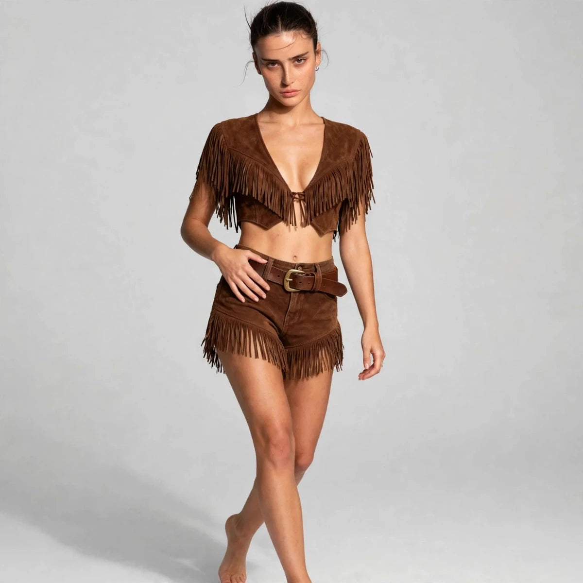 Model wearing brown fringed shorts set in a luxury fashion editorial