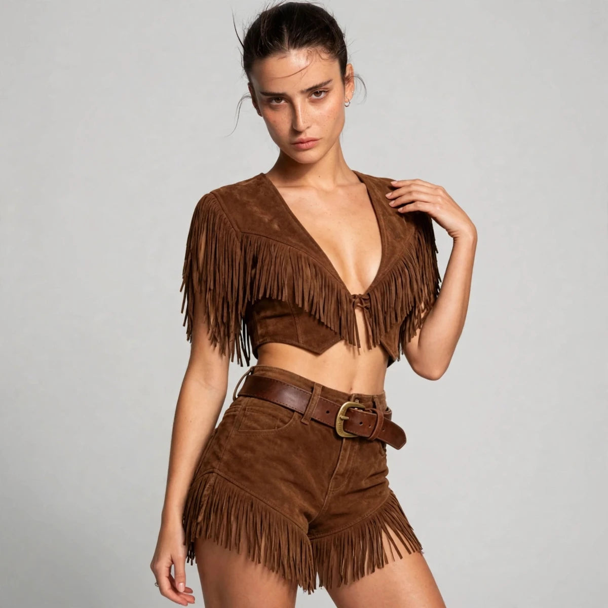 Three-quarter view of brown fringe crop top and shorts set with belt