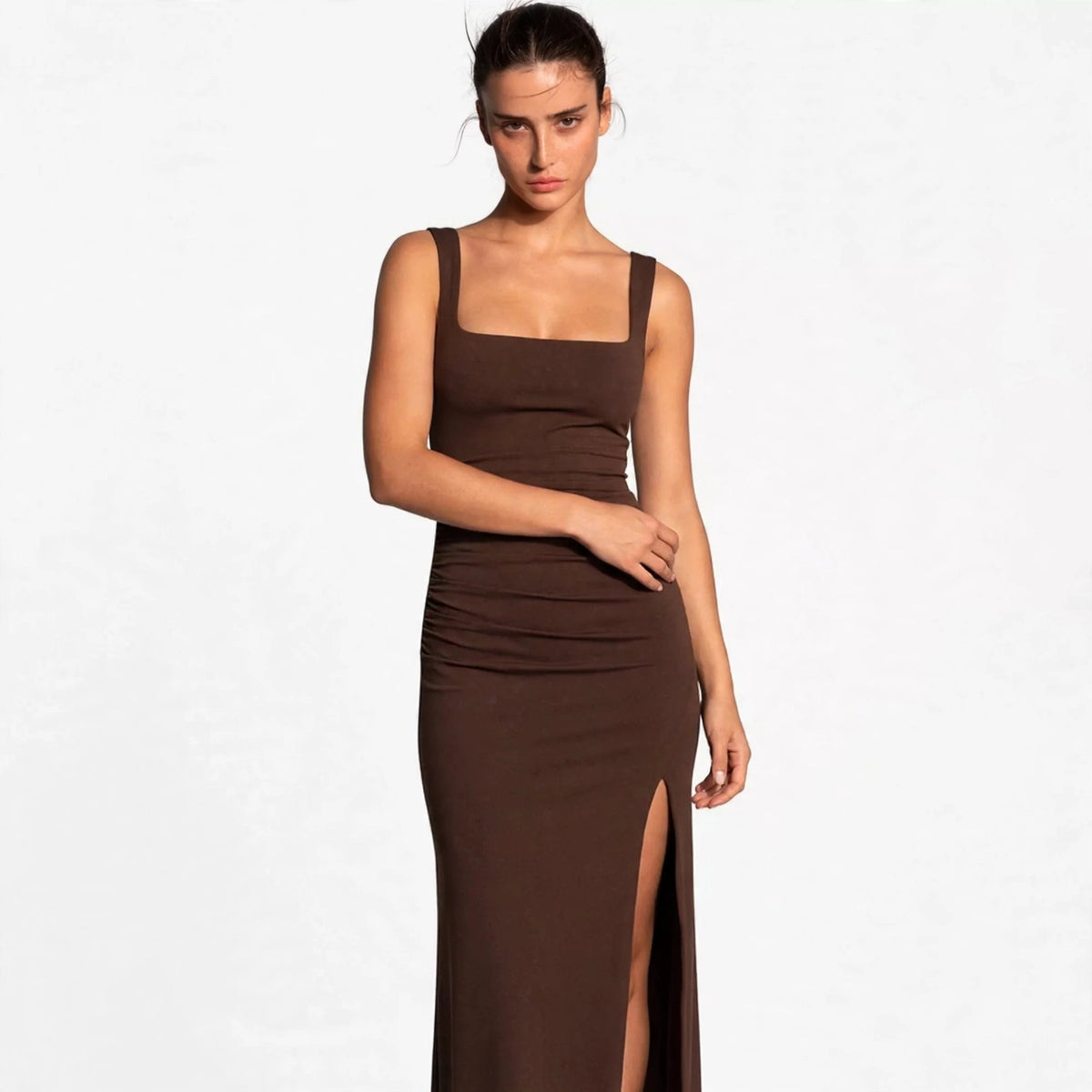 brown ruched high slit maxi dress – front view, arm across waist