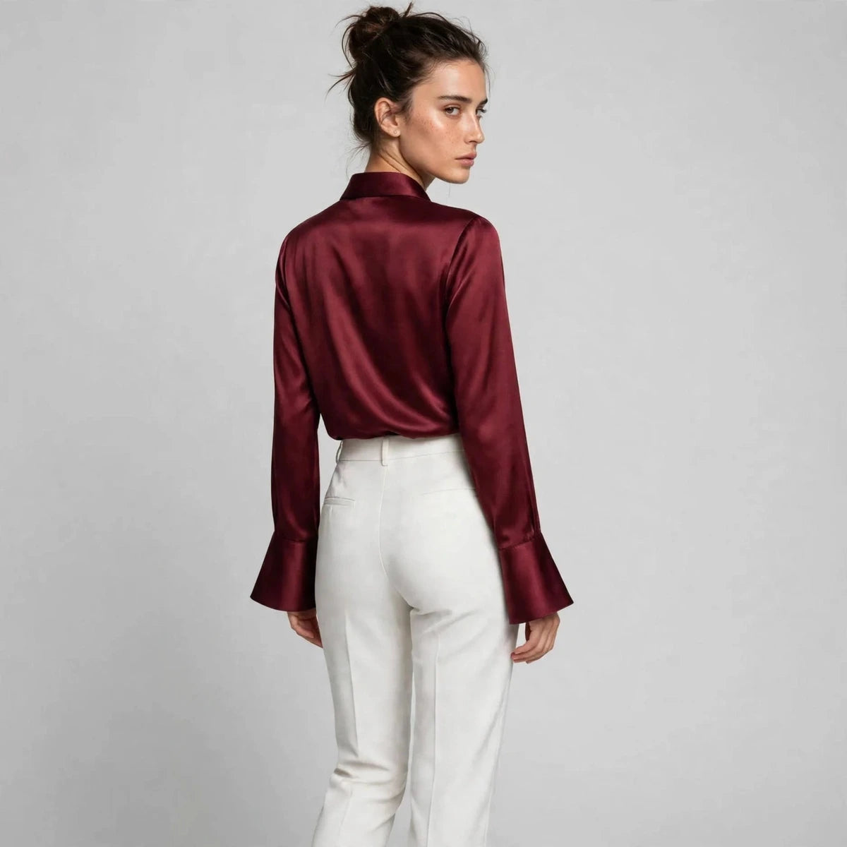 Back view of burgundy satin collar blouse with flared sleeves