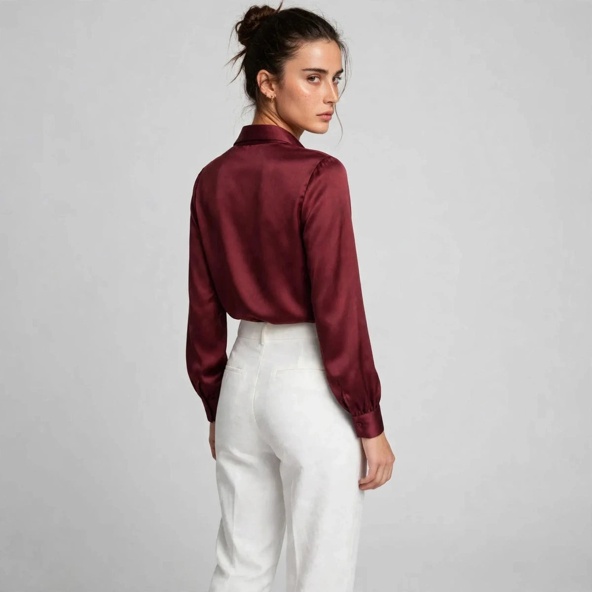 Back view of burgundy satin tie-neck blouse with shawl collar