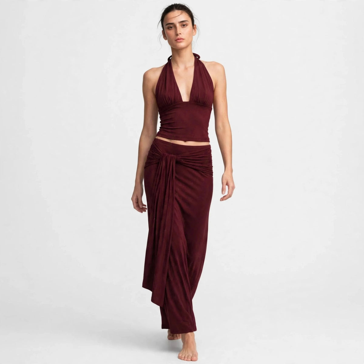 Back view of burgundy halter top with draped maxi skirt