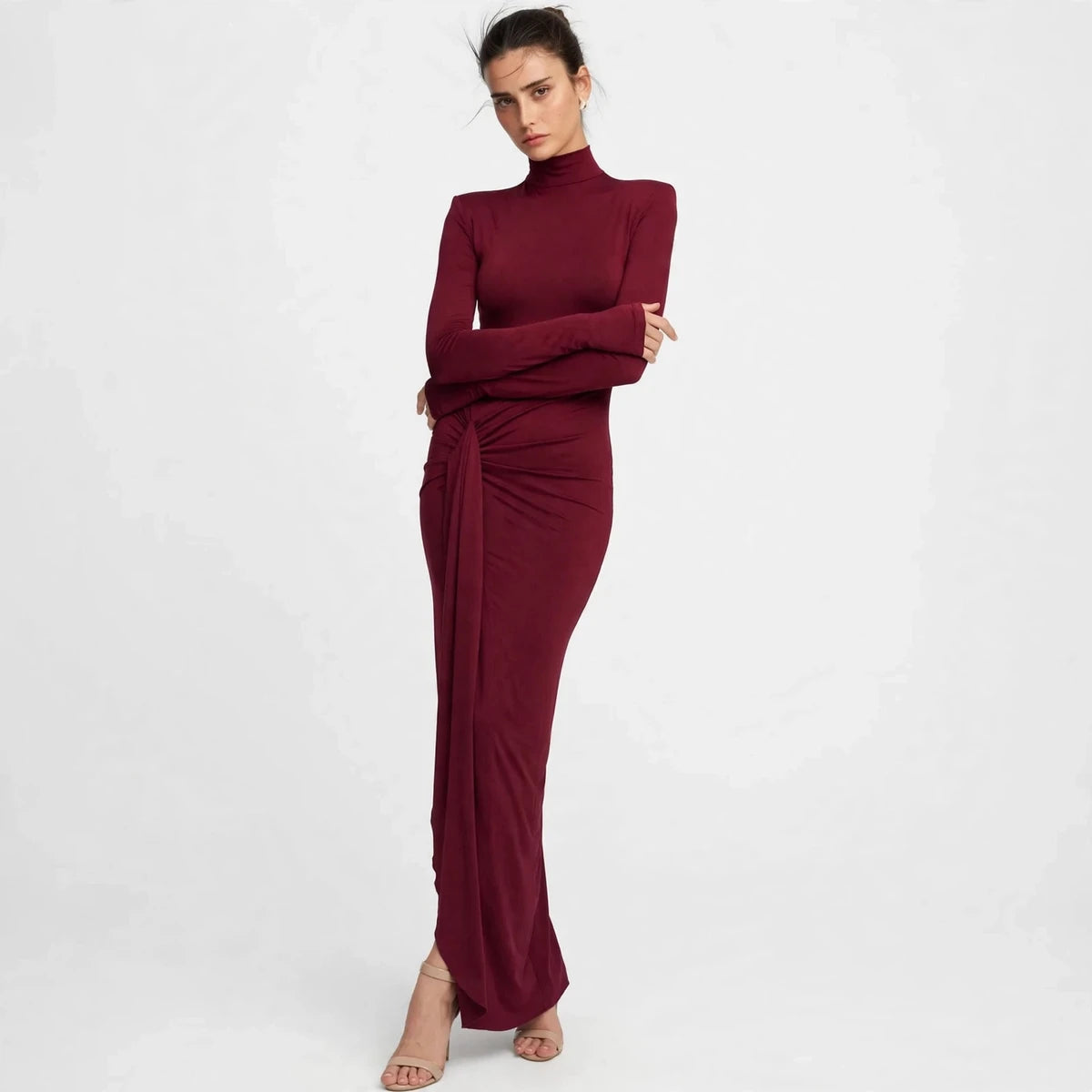Front view of burgundy turtleneck maxi dress with hand at the knotted tie waist