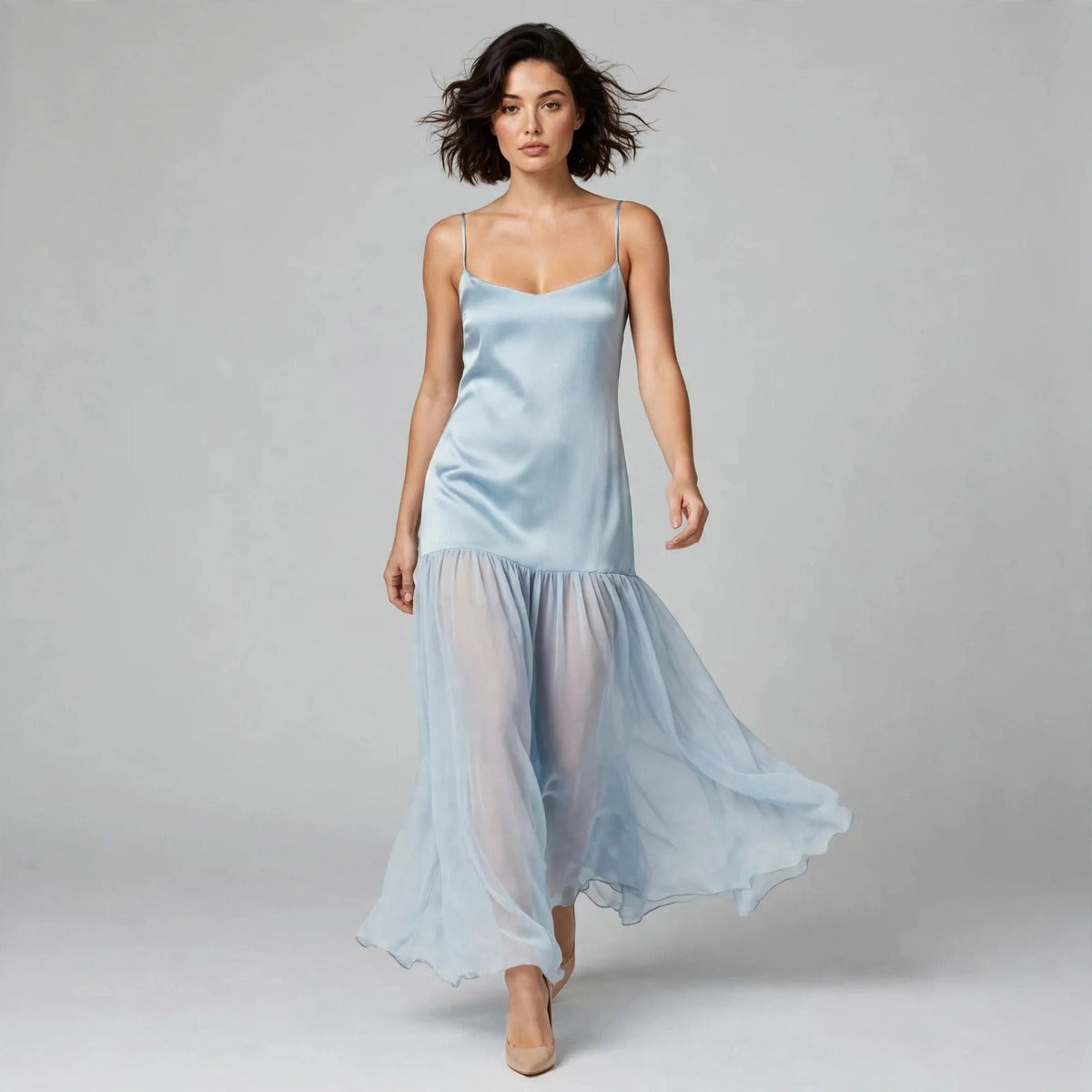 Model walking in light blue cami maxi dress with flowing sheer skirt
