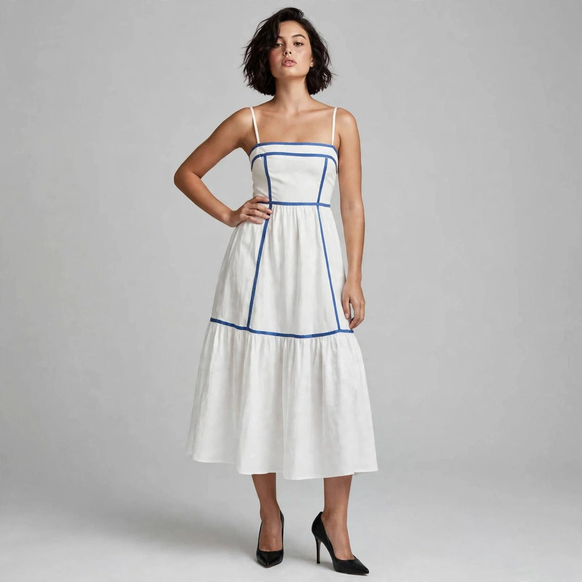 Woman wearing white cami midi dress with blue piping trim