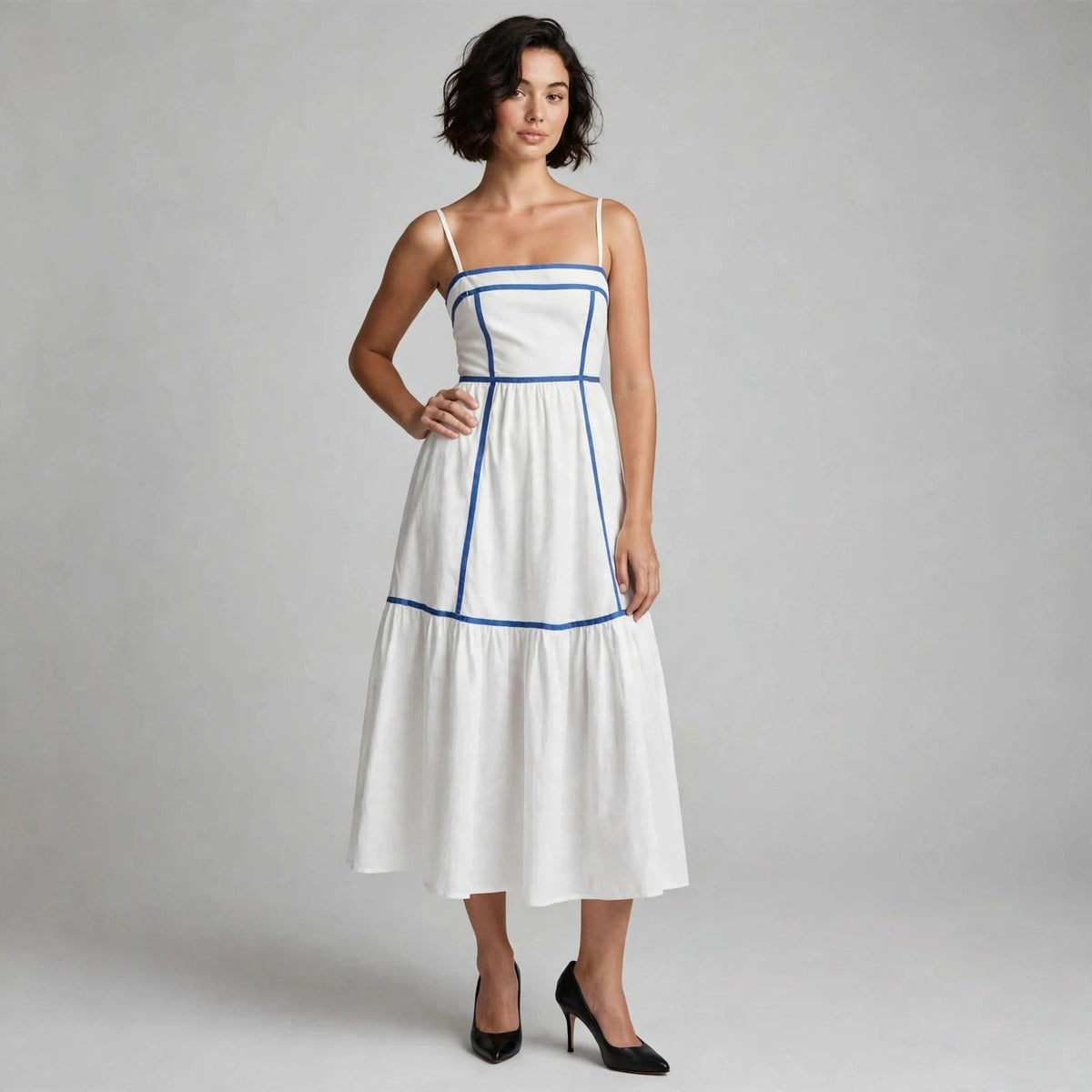 Front view of white cami midi dress with blue piping and tiered skirt