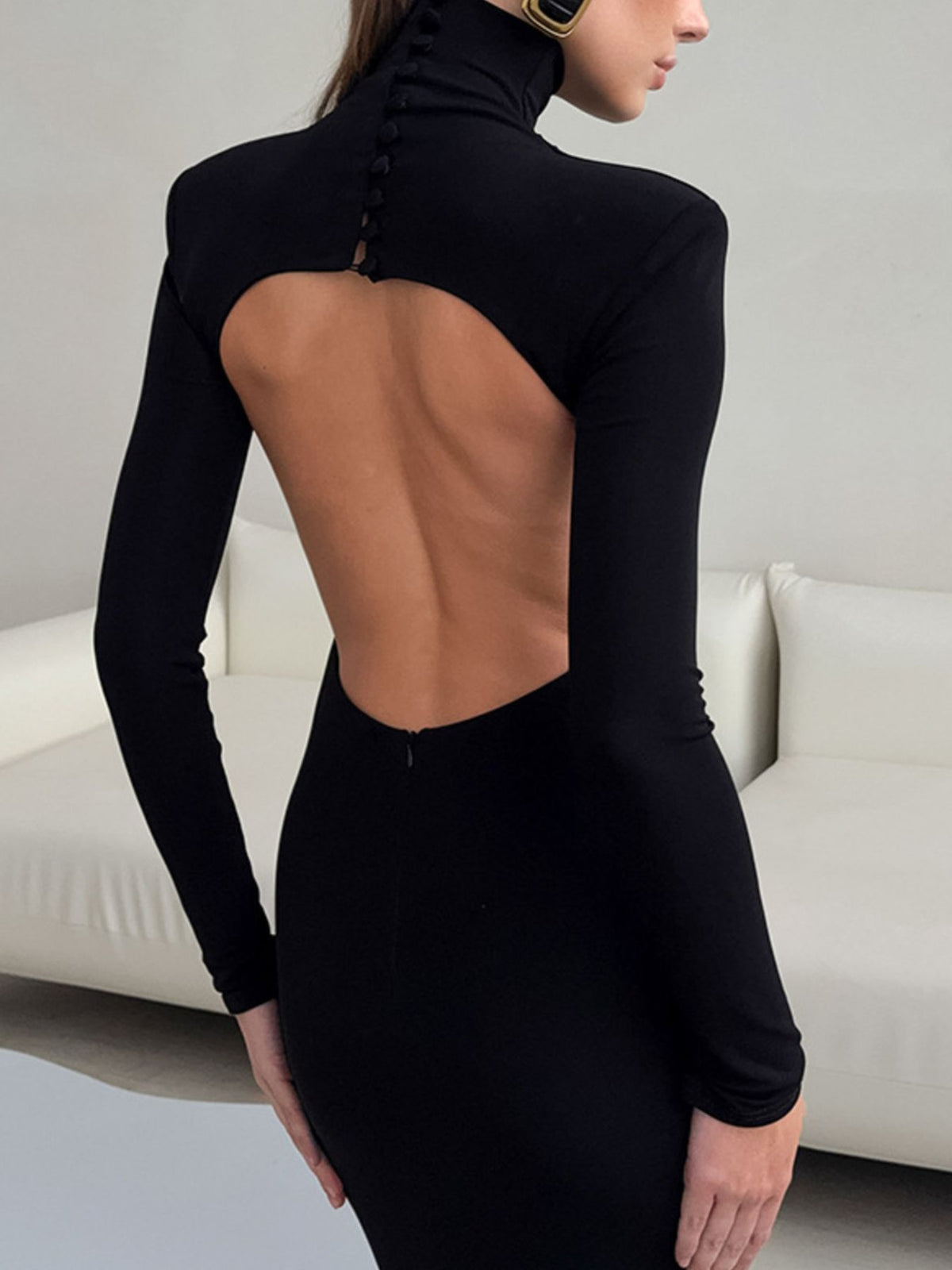 Back view of black long-sleeve bodycon maxi dress with open back cutout