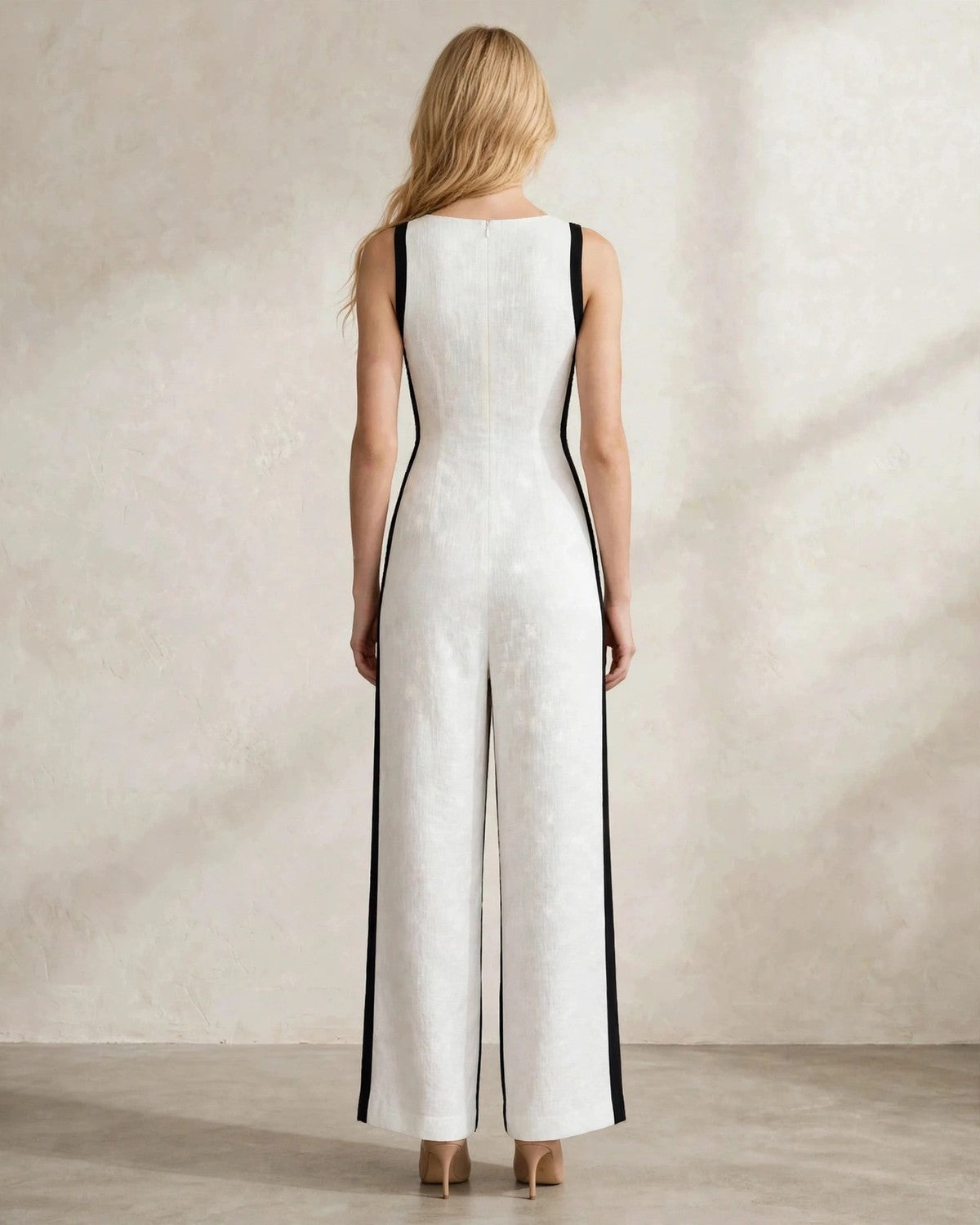 Women's contrast trim sleeveless jumpsuit in white with black trim, back view