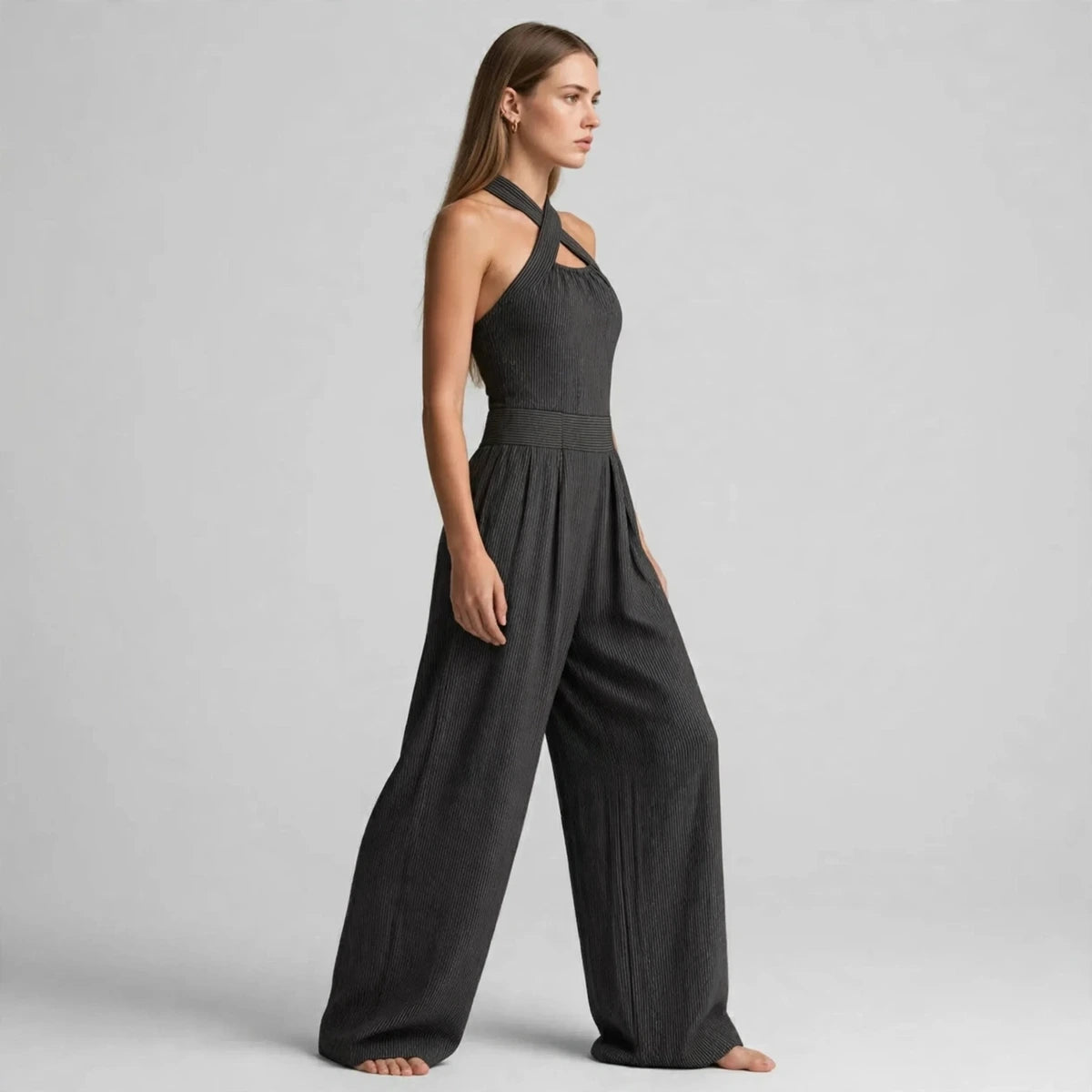 Side view of a dark gray crisscross halter jumpsuit with wide-leg pants