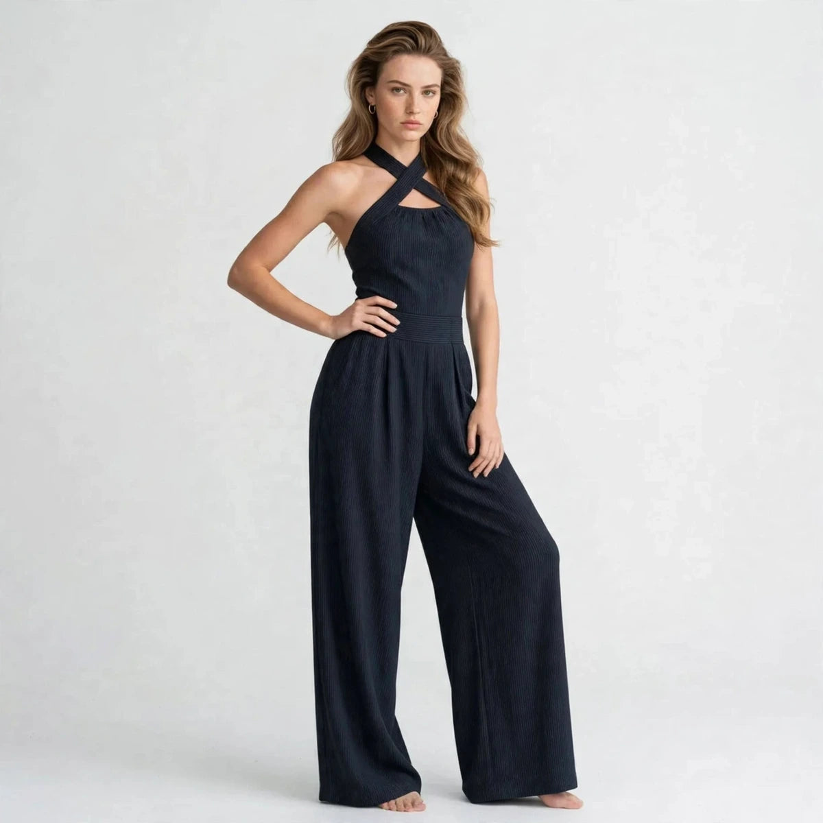Women's dark navy crisscross halter jumpsuit, three-quarter view