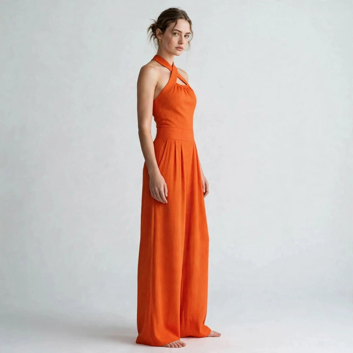 Women's orange crisscross halter jumpsuit, side view