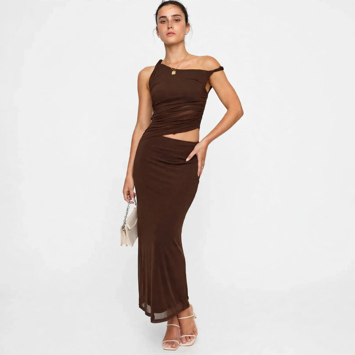 dark brown asymmetrical cutout maxi dress – three-quarter view, hand on hip