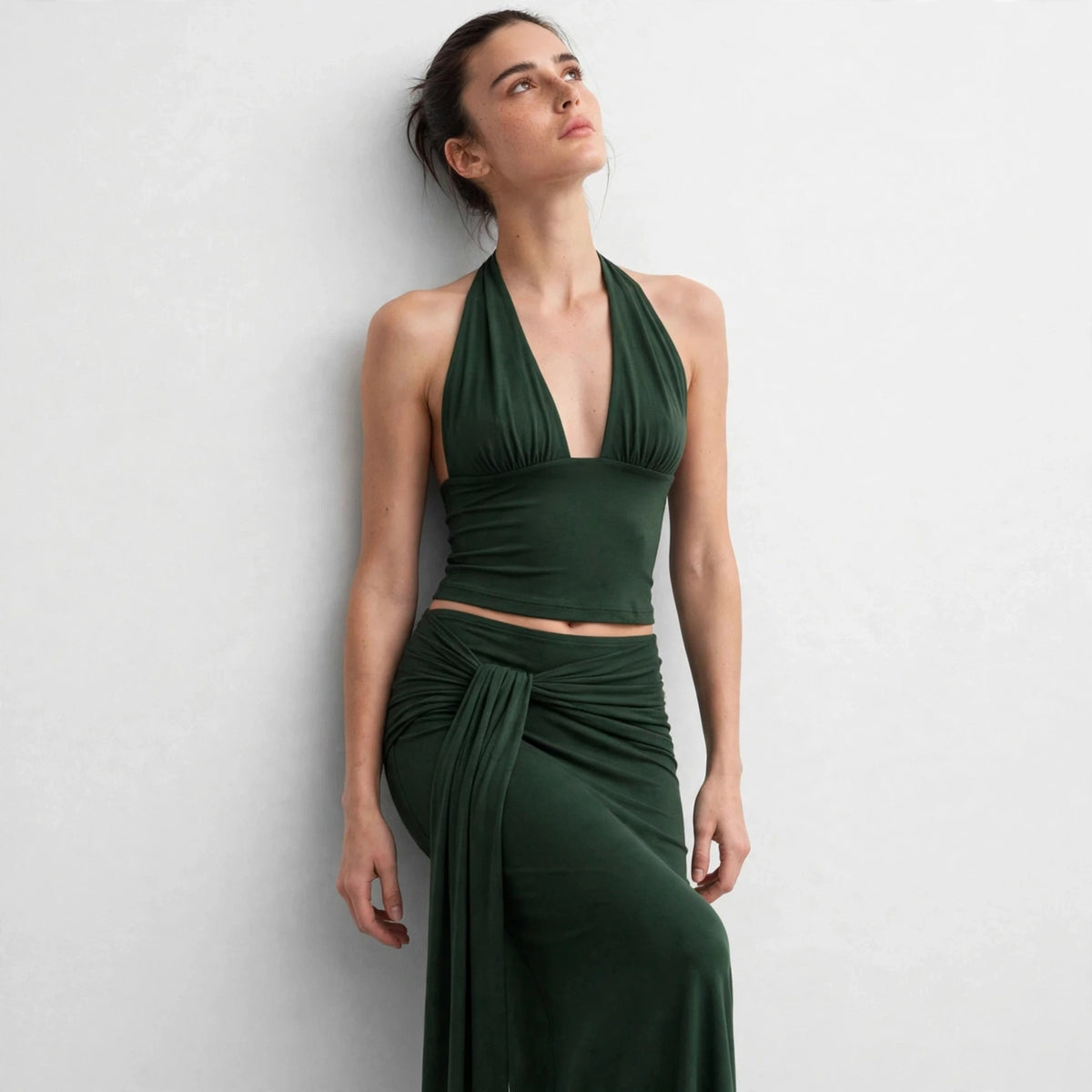 Side view of dark green halter top and draped maxi skirt