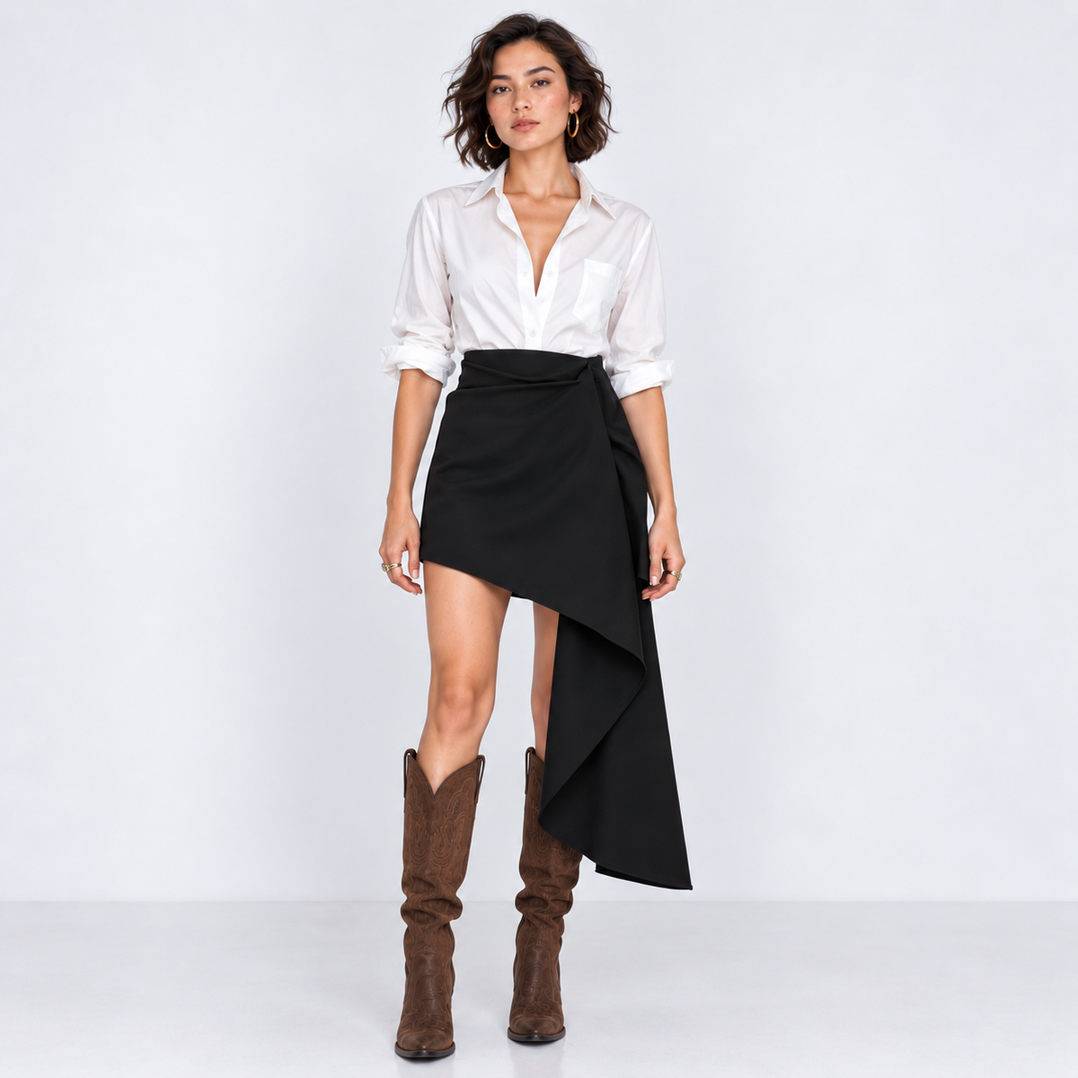 Woman wearing black draped mini skirt with long side drape, front view