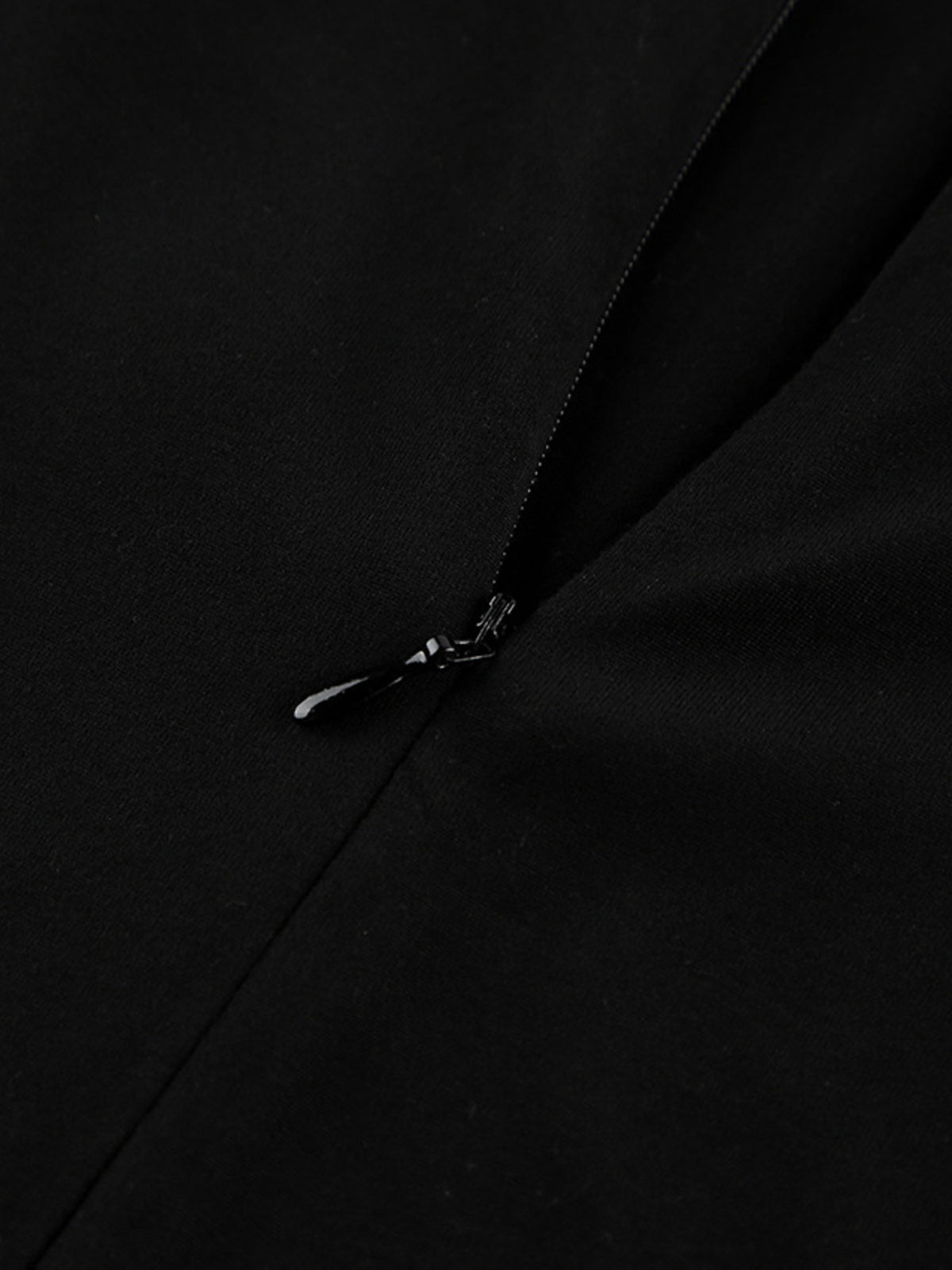 Close-up of back zipper closure on black bodycon maxi dress