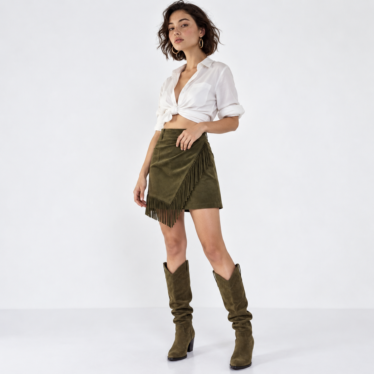 Three-quarter view of olive fringe wrap skirt styled with white shirt