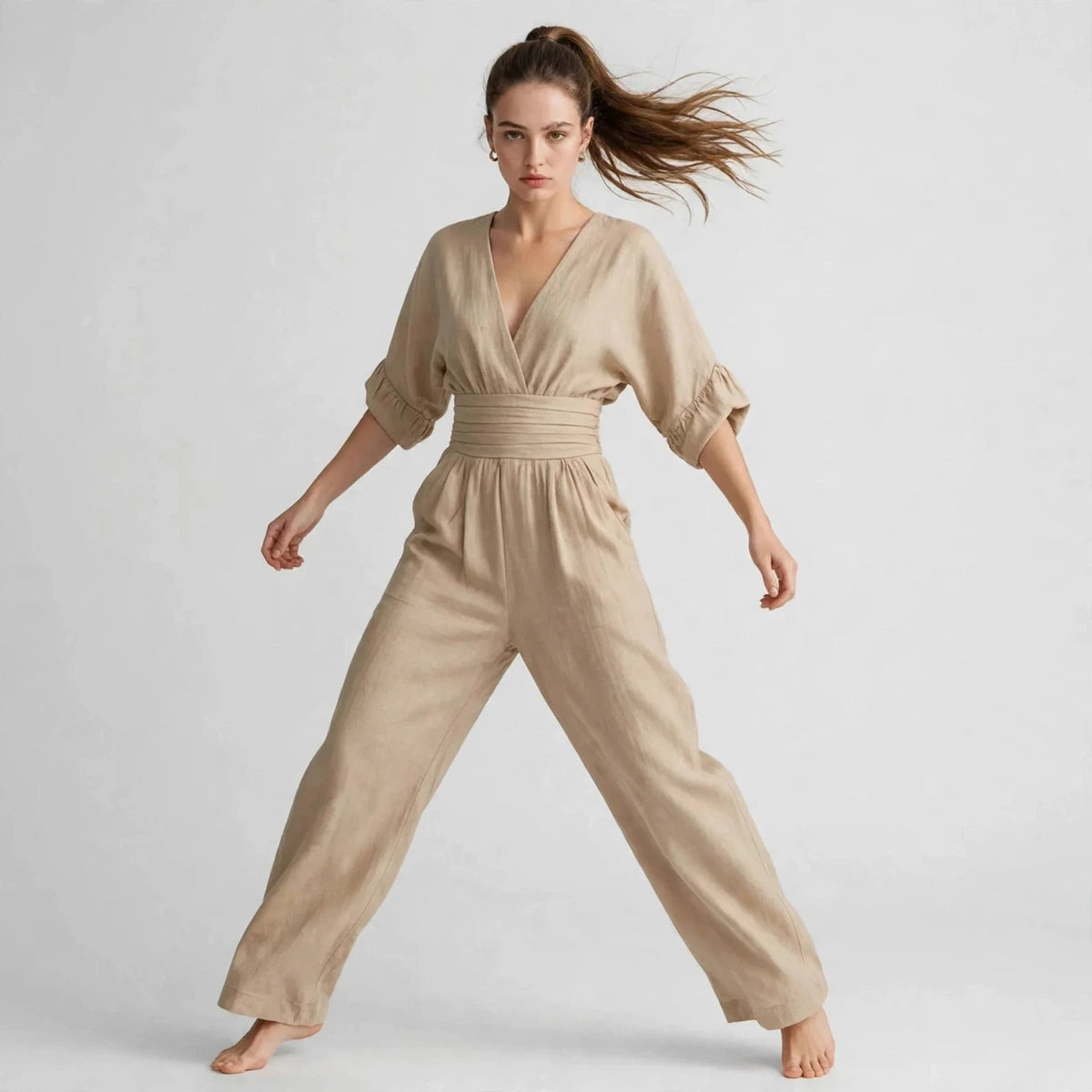 Model wearing beige half sleeve jumpsuit in a fashion editorial