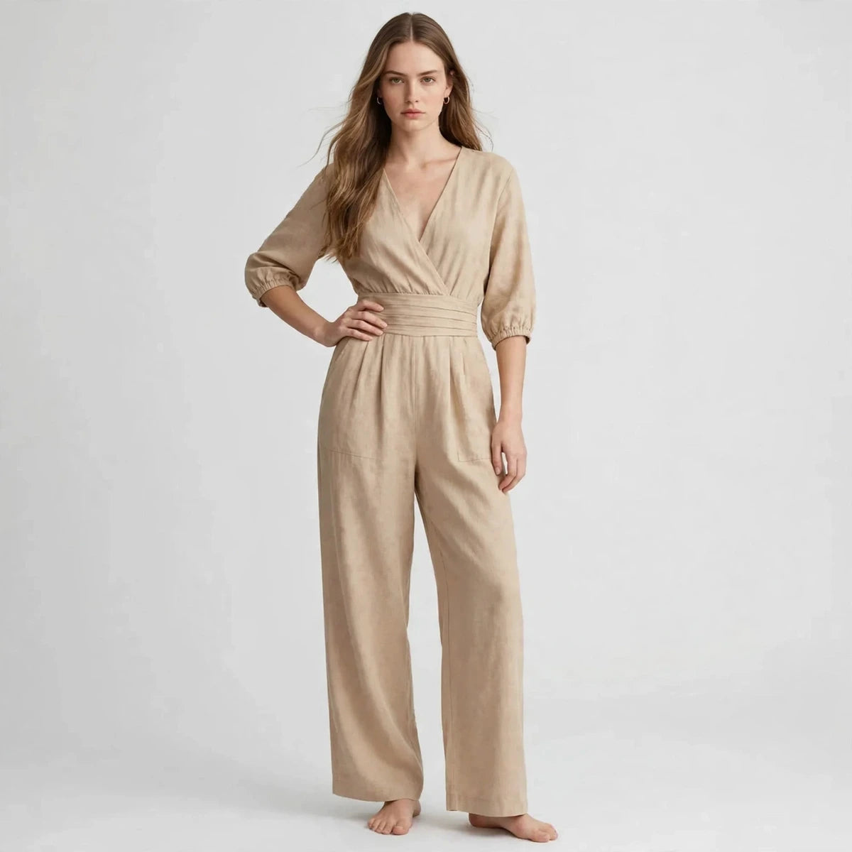 Woman wearing beige half sleeve jumpsuit with smocked waist