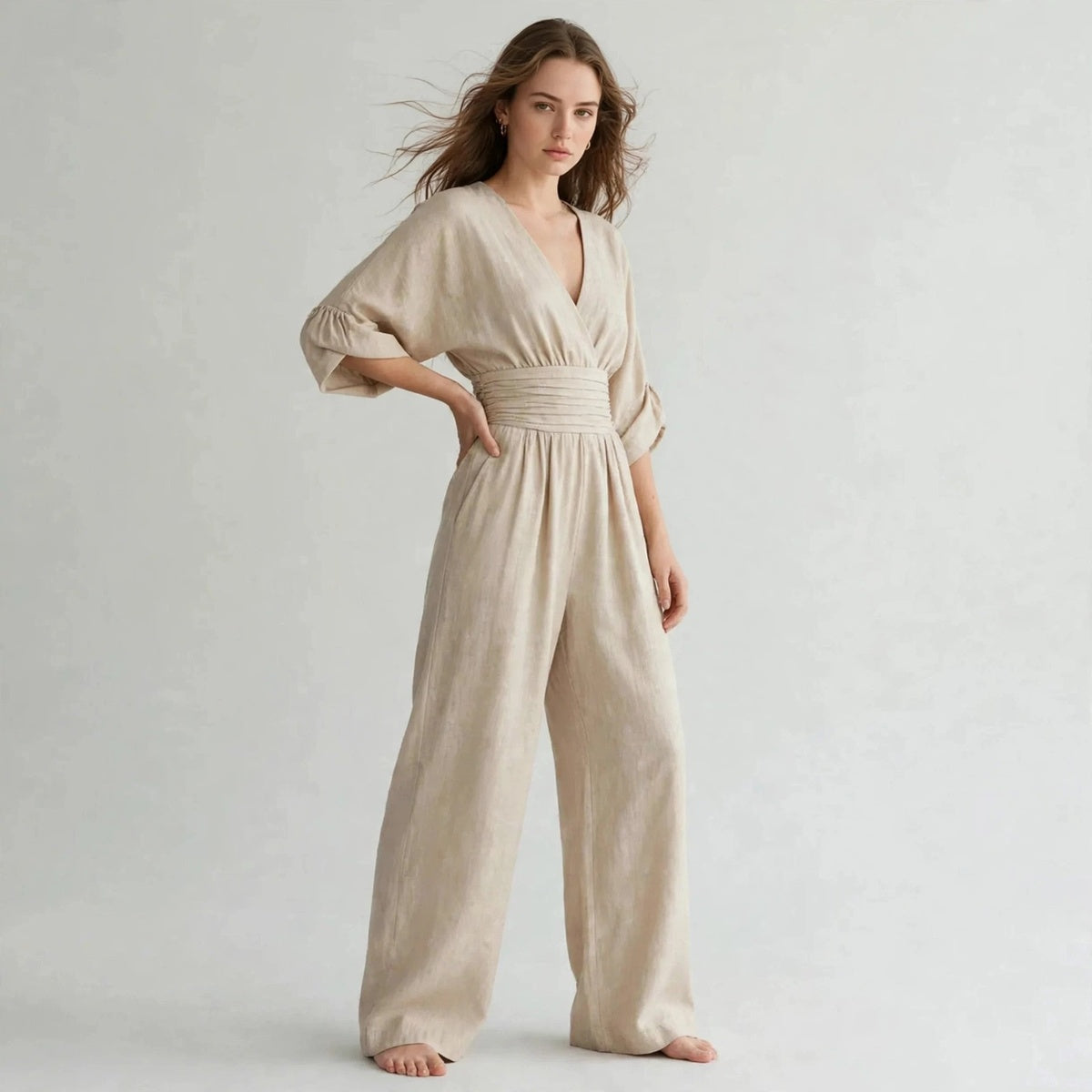 Side view of beige half sleeve jumpsuit with smocked waist