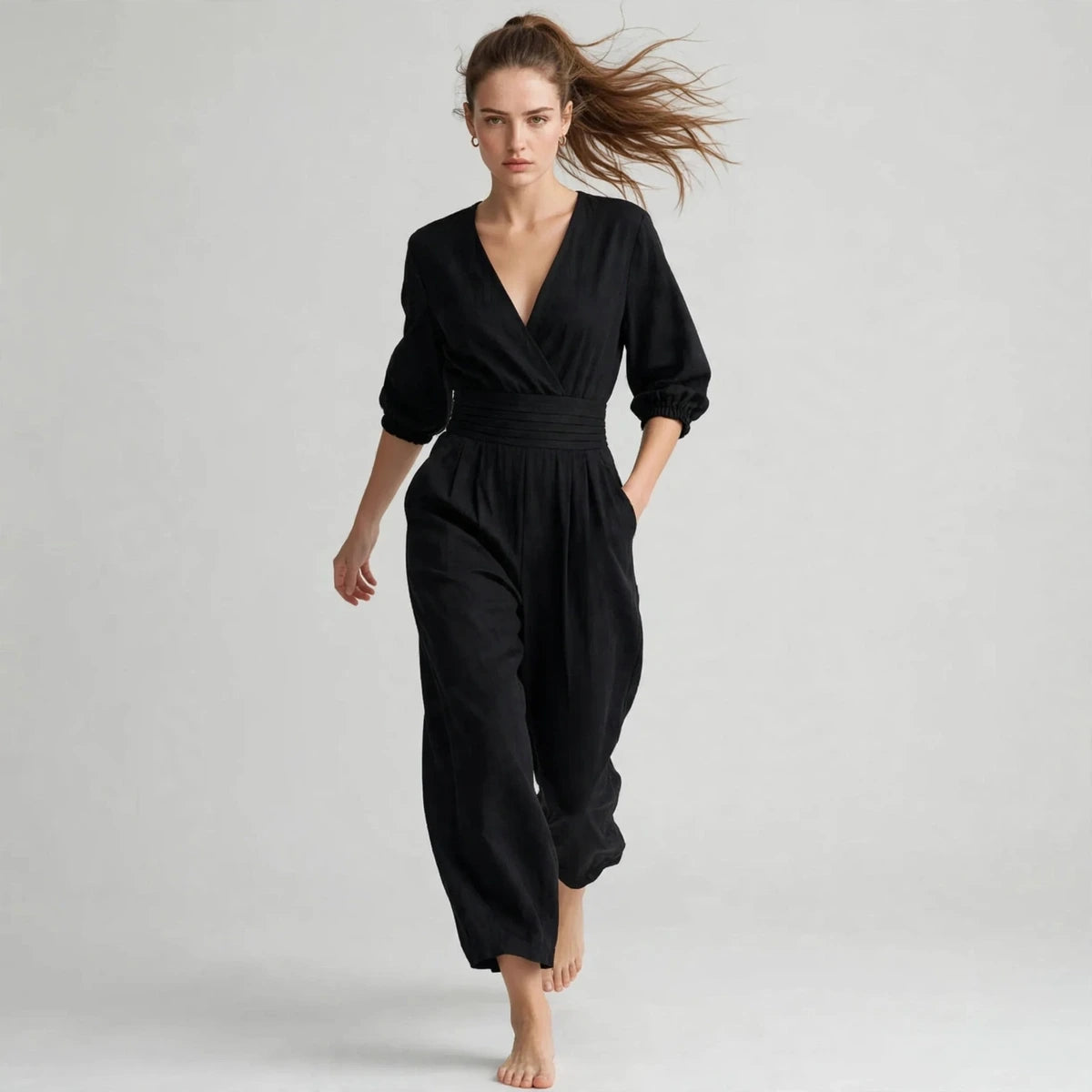 Model walking in black half sleeve jumpsuit, editorial shot