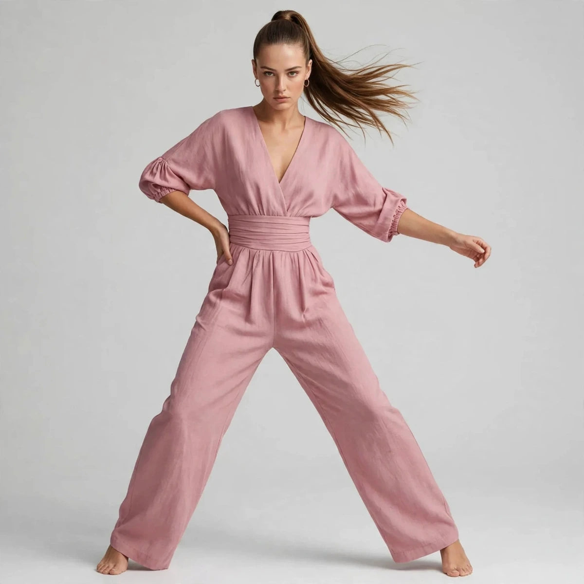 Model wearing dusty pink half sleeve jumpsuit in a fashion editorial