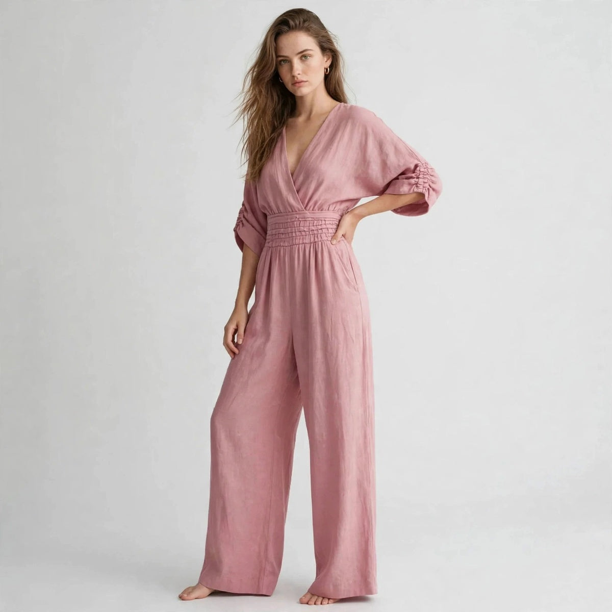 Side view of dusty pink half sleeve jumpsuit with wide leg pants