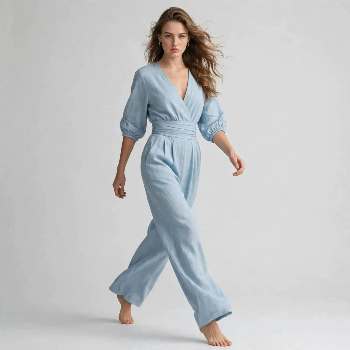 Model walking in light blue half sleeve jumpsuit, editorial shot