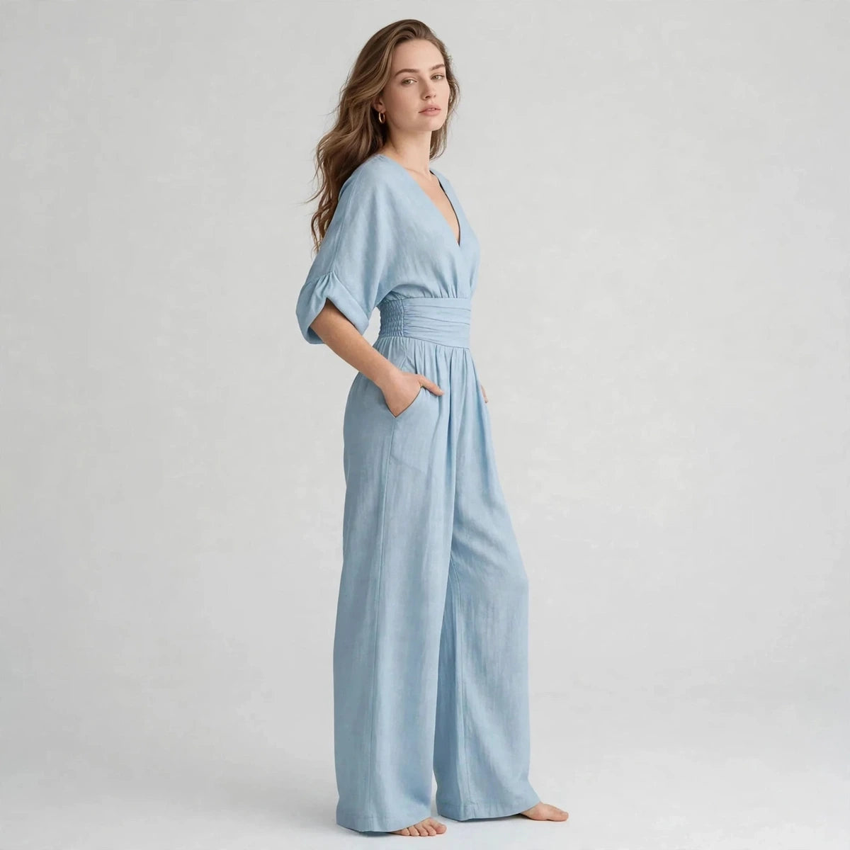 Side view of light blue half sleeve jumpsuit with wide leg pants