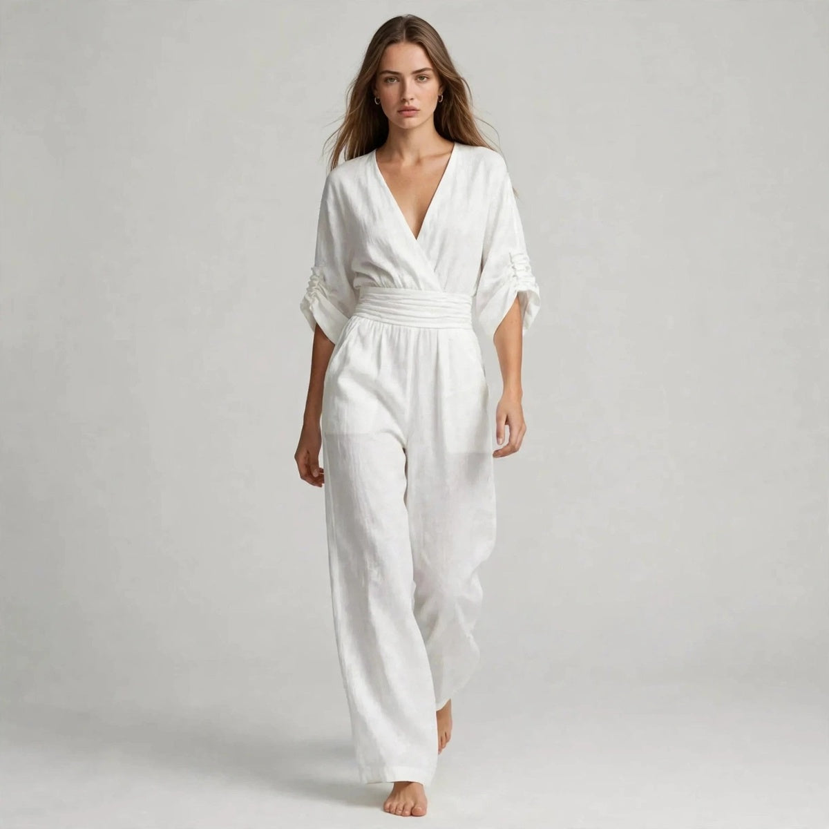 Model wearing white half sleeve jumpsuit in a fashion editorial