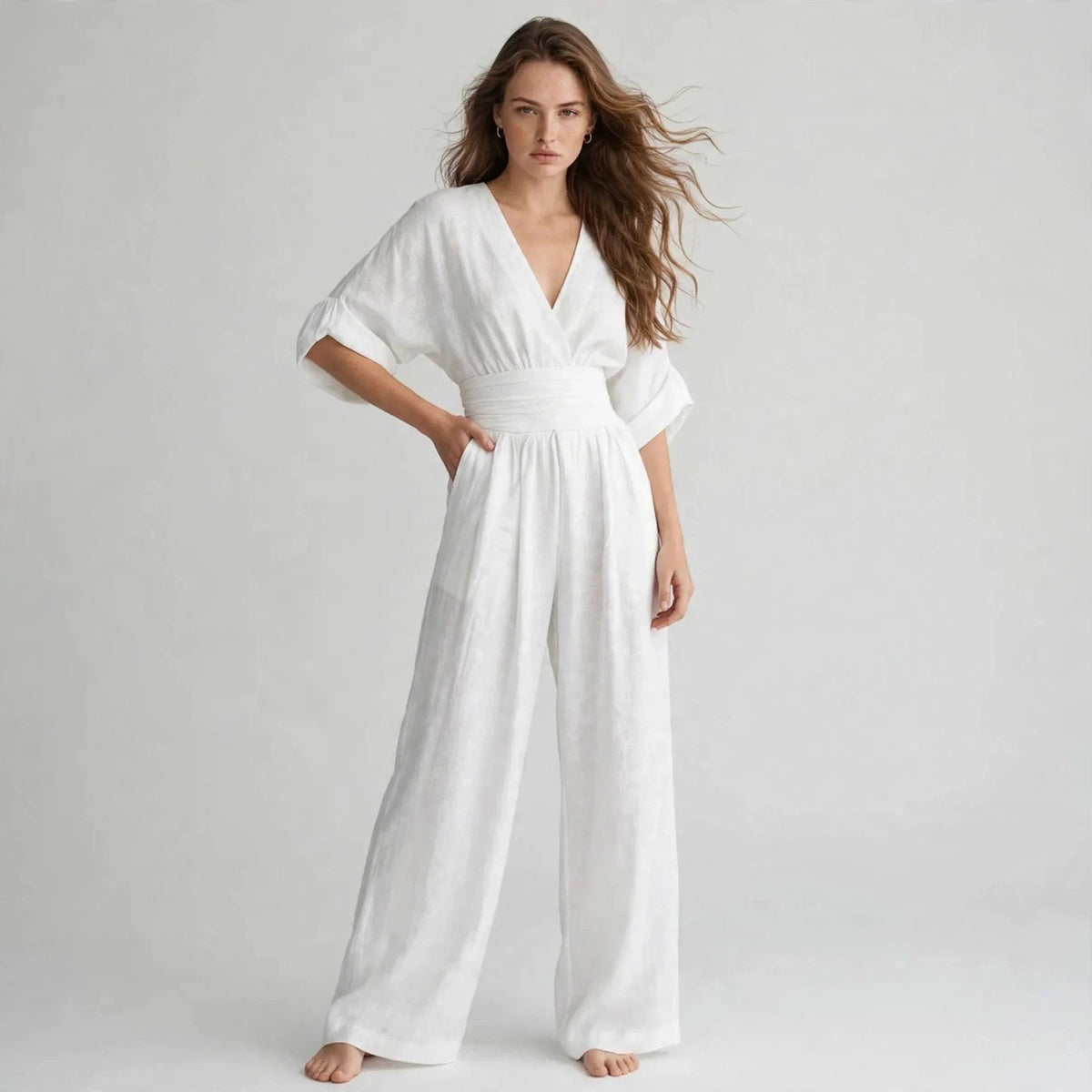 White half sleeve jumpsuit with smocked waist, walking pose