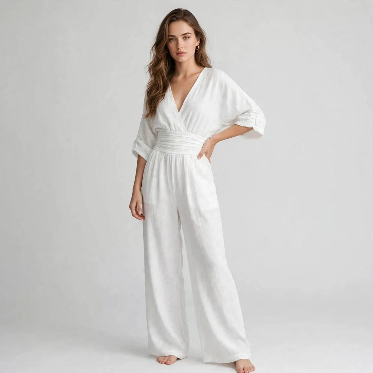 Side view of white half sleeve jumpsuit with wide leg pants