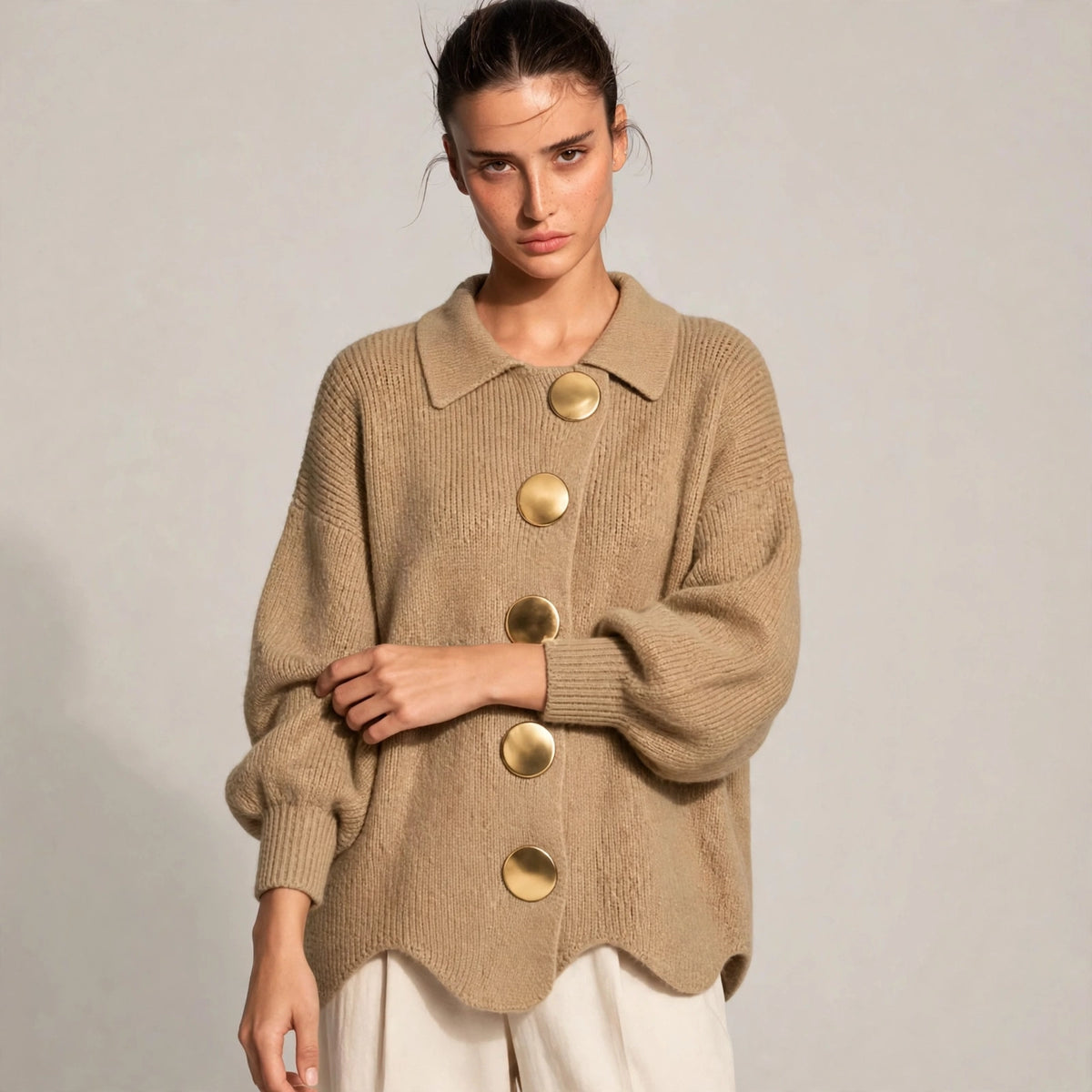 Woman wearing khaki gold-button knit cardigan with lantern sleeves, front view