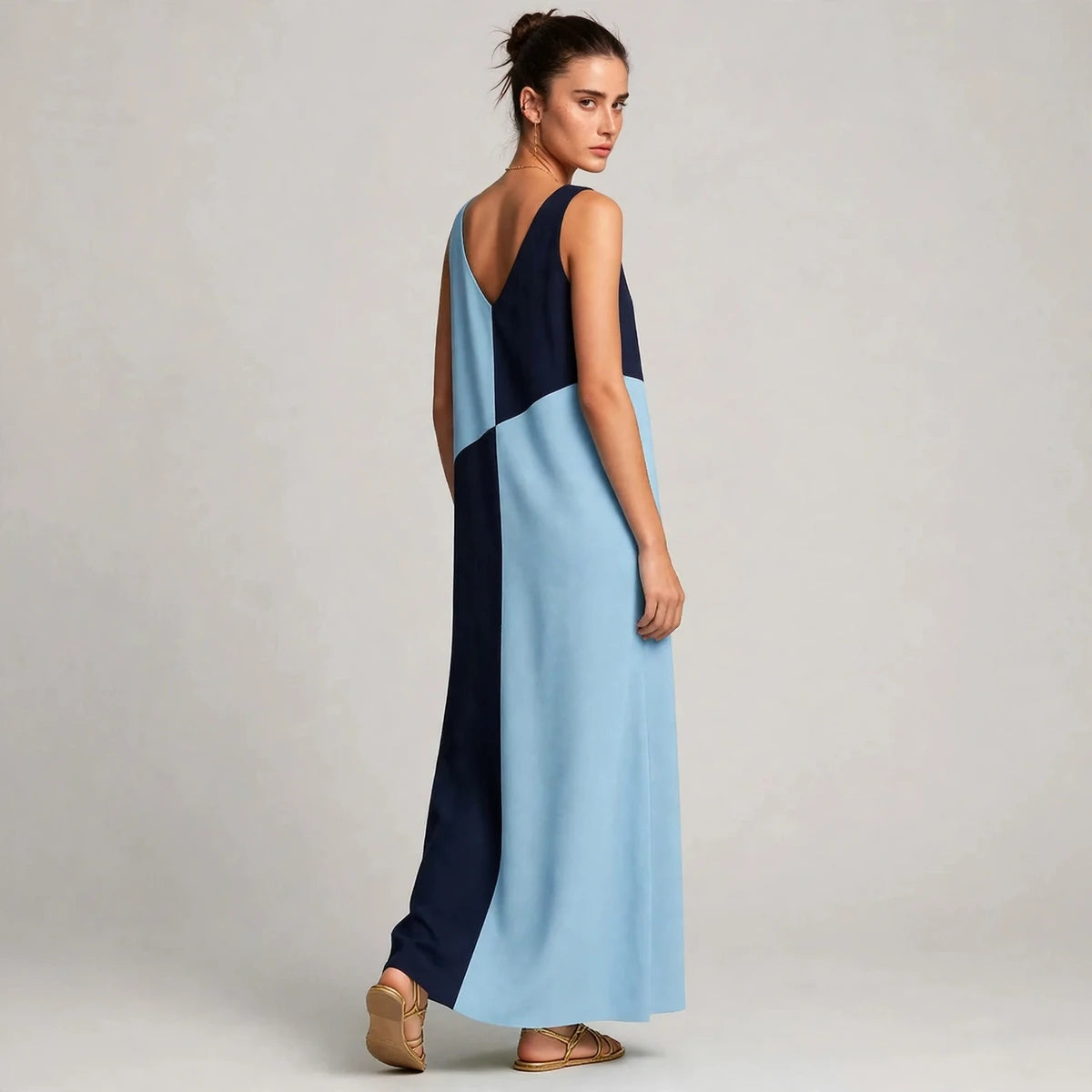 Back detail view of light blue and navy color-block maxi dress showing V back neckline