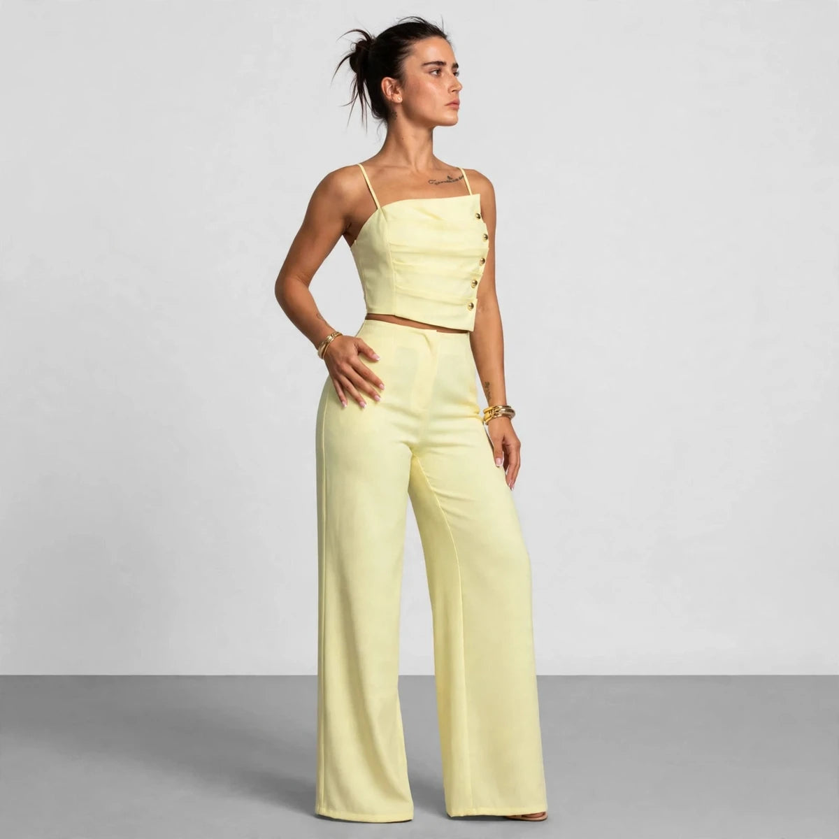 Side view of light yellow button cami top and wide-leg pants set