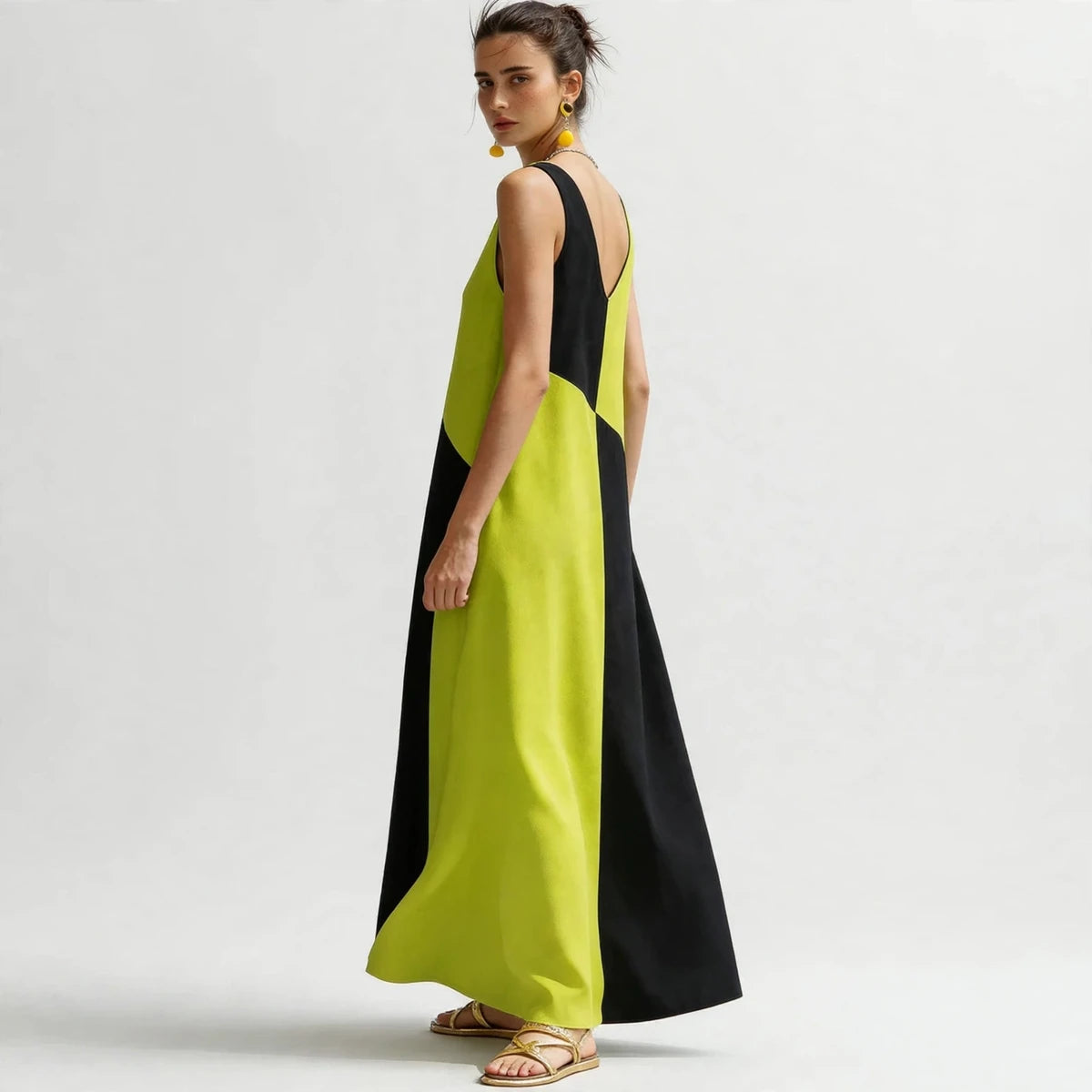 Back view of lime green and black color-block sleeveless maxi dress