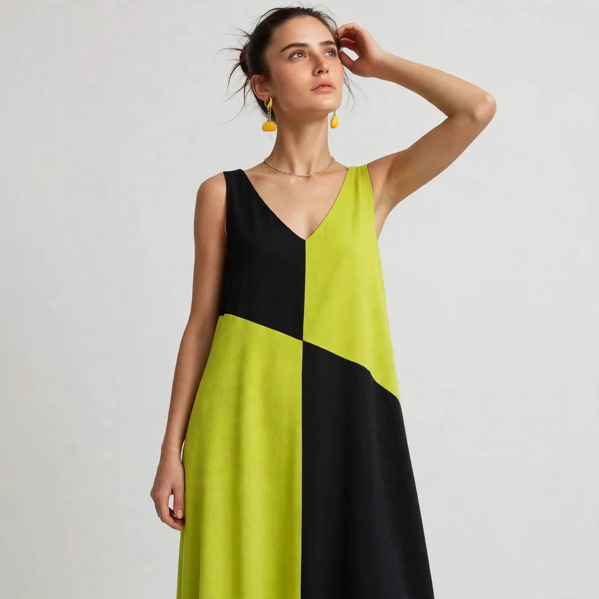 Close view of lime green and black color-block V-neck maxi dress showing bodice panel detail