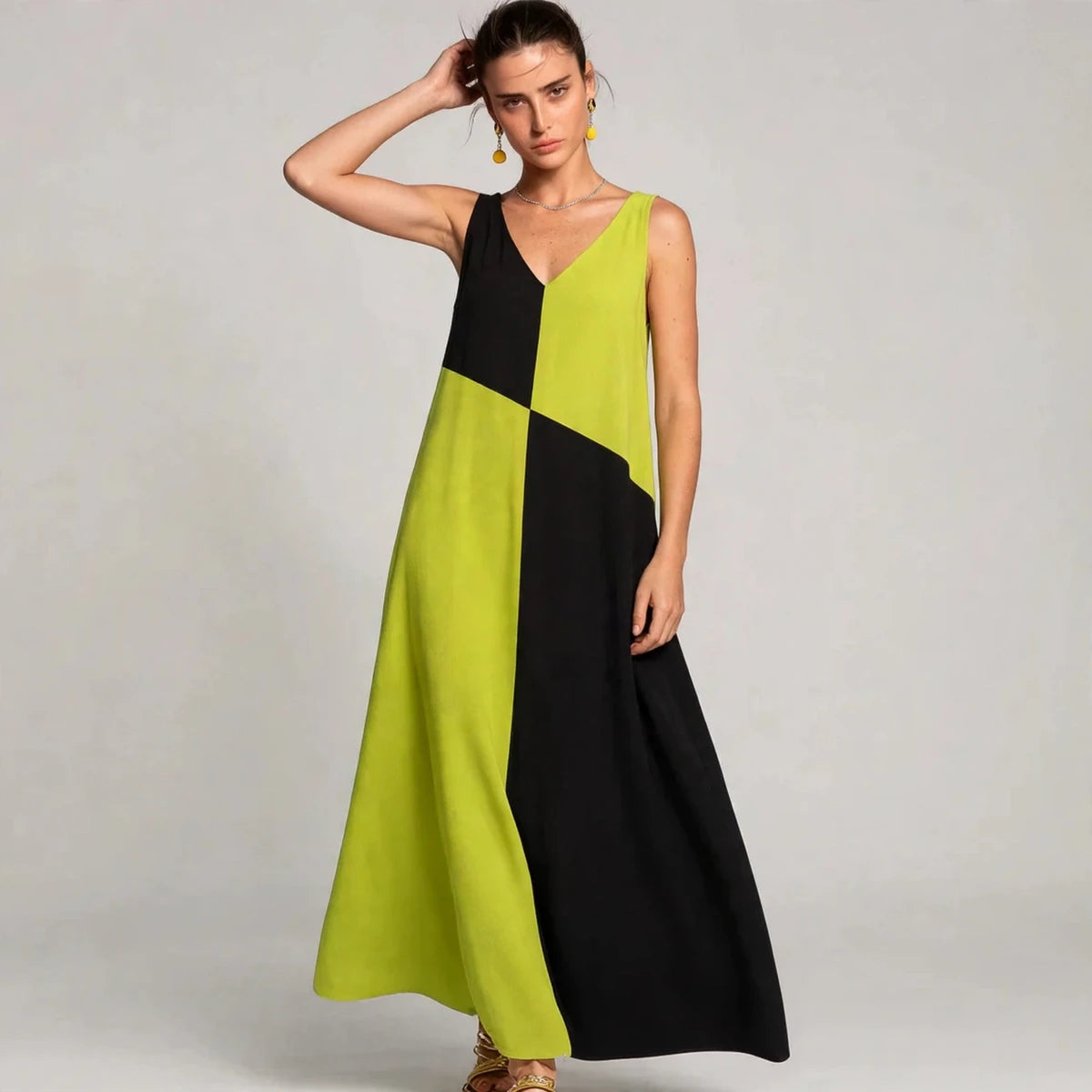 Woman wearing lime green and black color-block sleeveless V-neck maxi dress, front view
