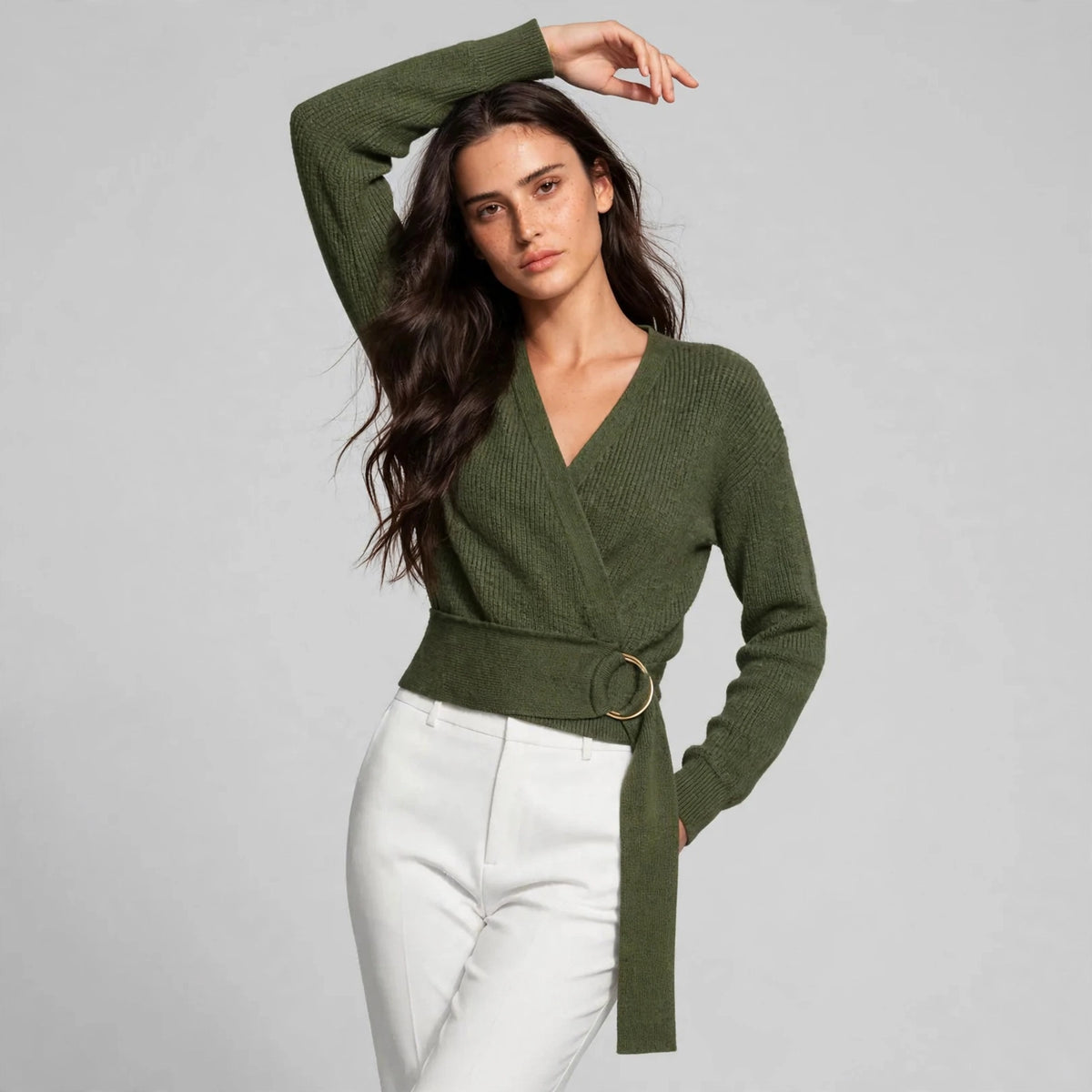 Styled pose showing army green ring wrap sweater with ribbed knit texture