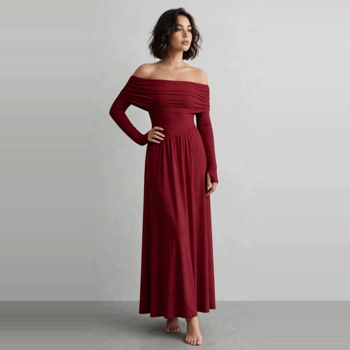 Model wearing burgundy off-shoulder long sleeve maxi dress in a studio editorial