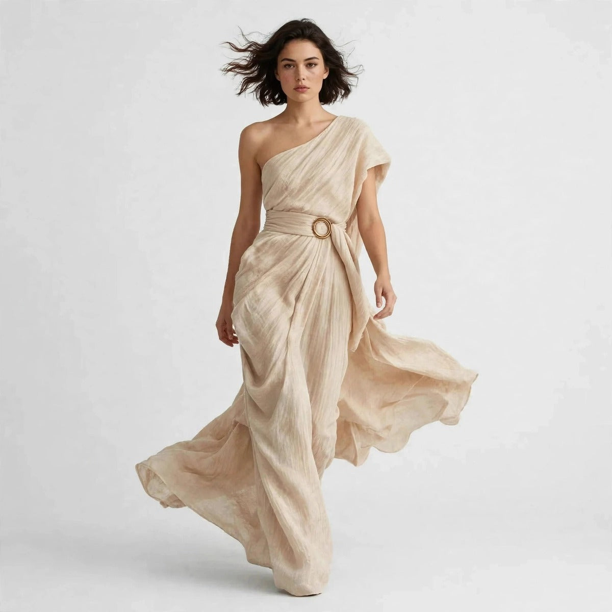 Model walking in tan draped one-shoulder maxi dress with side slit